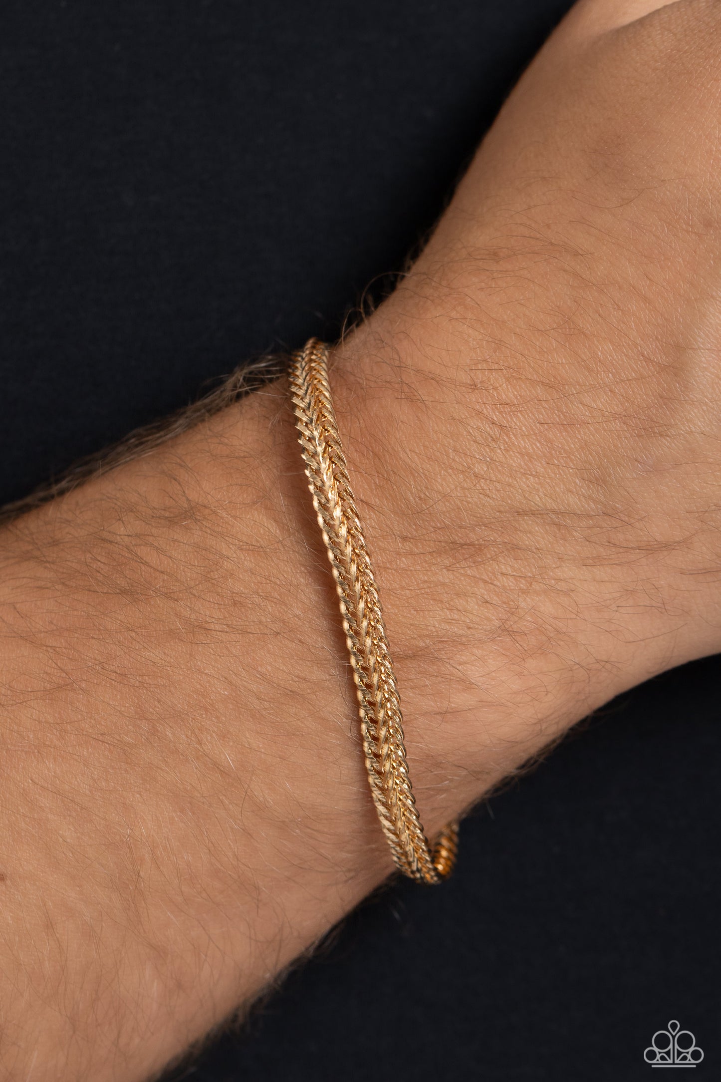 Paparazzi Accessories Cable Train - Gold Intricate gold chains interlock into an edgy centerpiece around the wrist, resulting in a gritty statement piece. Features a magnetic closure. Sold as one individual bracelet. Jewelry