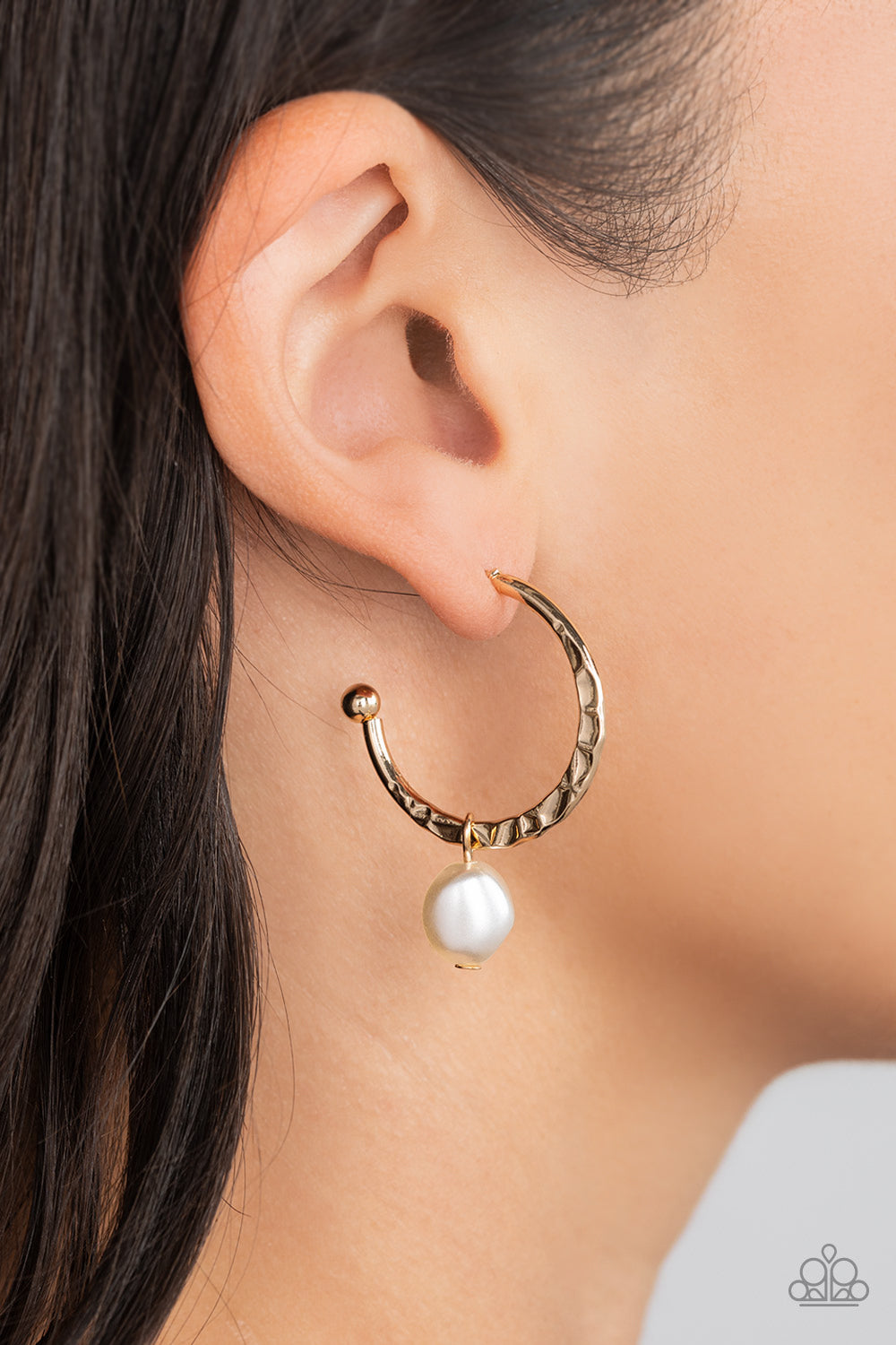Paparazzi Accessories GLAM Overboard - Gold An imperfect white pearl glides along a hammered gold hoop, creating a timeless twist. Earring attaches to a standard post fitting. Hoop measures approximately 1" in diameter. Sold as one pair of hoop earrings.