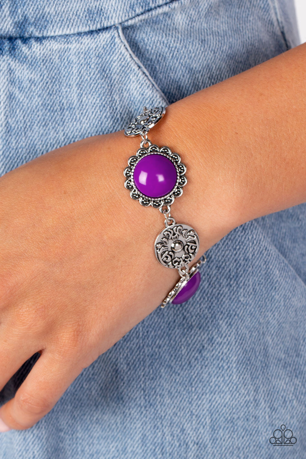 Paparazzi Accessories Positively Poppy - Purple Shiny oversized Dahlia beads are wrapped in floral-inspired frames of silver, filled with studded texture. Silver discs embossed in a filigree motif alternate with the vibrant beads as they link around the w