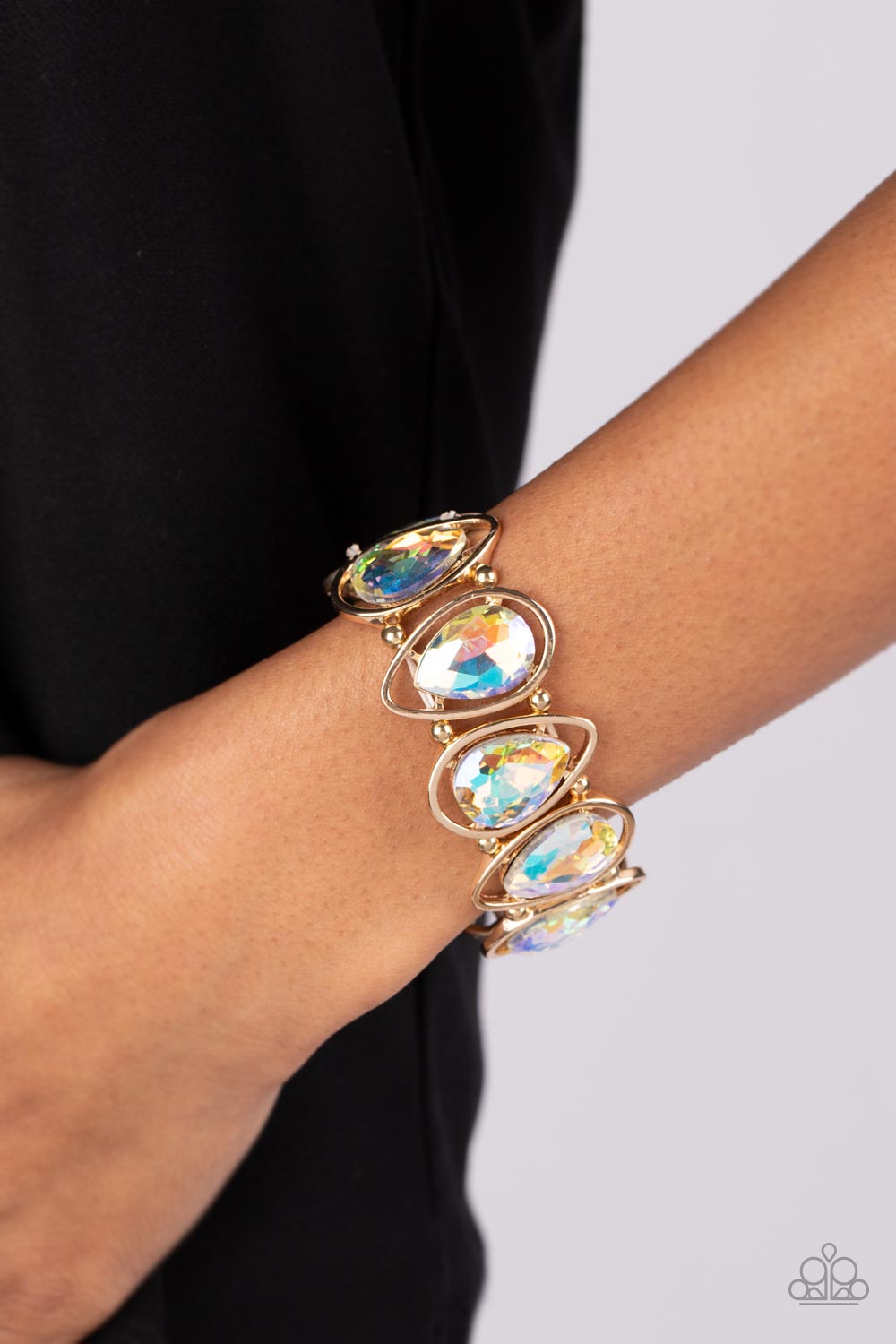 Paparazzi Accessories The Sparkle Society - Gold Oversized teardrop gems, coated in a shimmery iridescent finish are seemingly suspended inside gold teardrop frames. The airy borders allow the faceted edges of the iridescent beads to take center stage, as