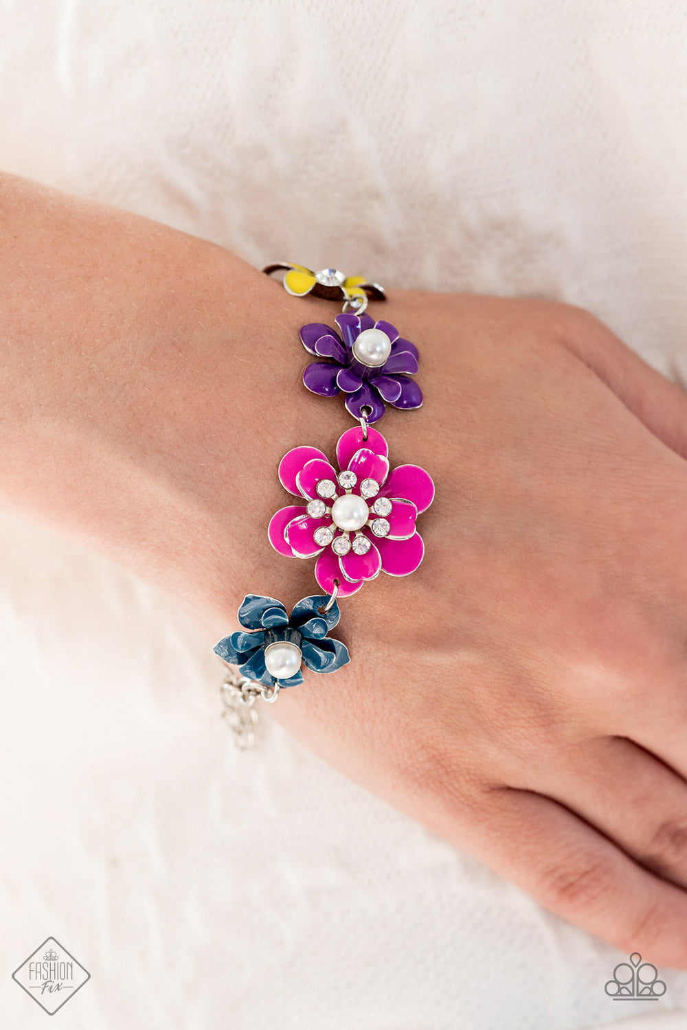 Paparazzi Accessories Flower Patch Fantasy - Multi A collection of colorful flowers link around the wrist to create a vibrant statement piece. A mix of shimmery pearls and sparkling white rhinestones decorate the center of each flower, infusing the piece
