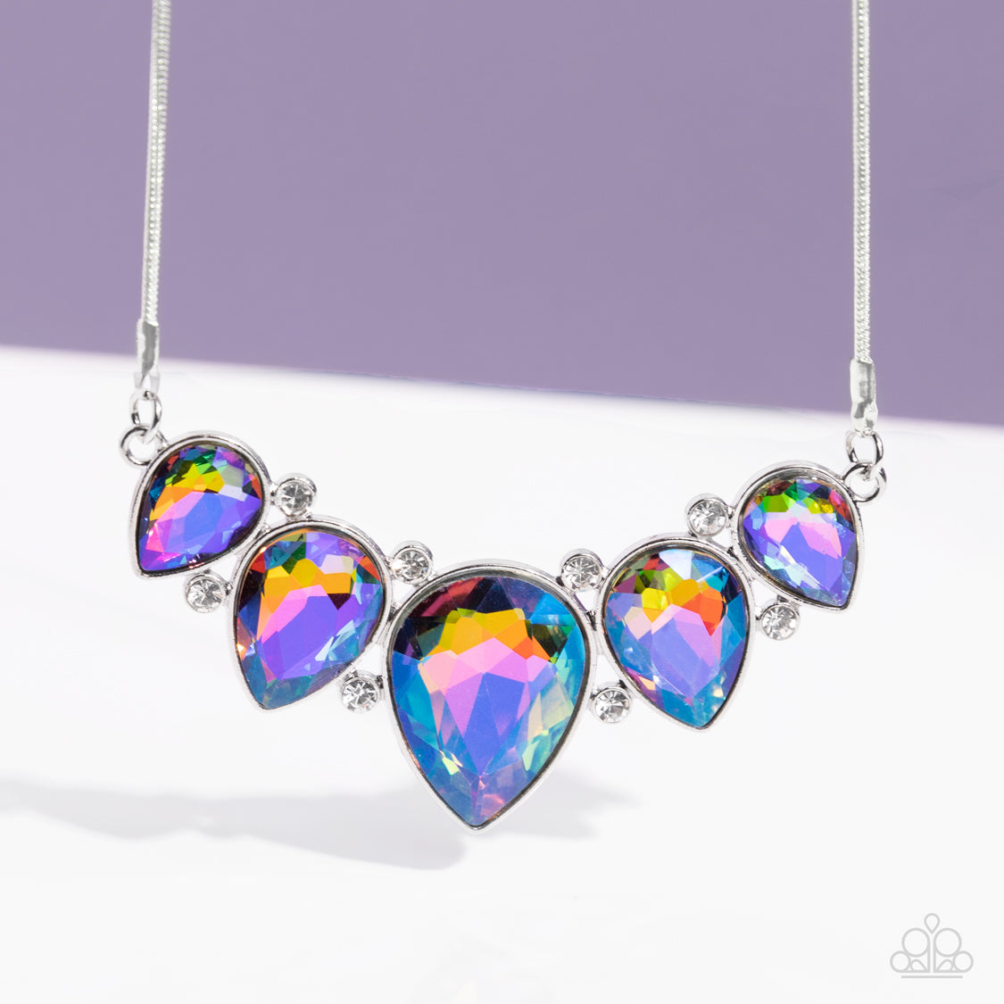 Paparazzi Accessories Regally Refined - Multi Featuring a stellar UV shimmer, dramatic teardrop gems, gliding from a sleek, silver snake chain, are pressed into high-sheen silver casings, creating a colorful fringe below the collar. Linking each teardrop