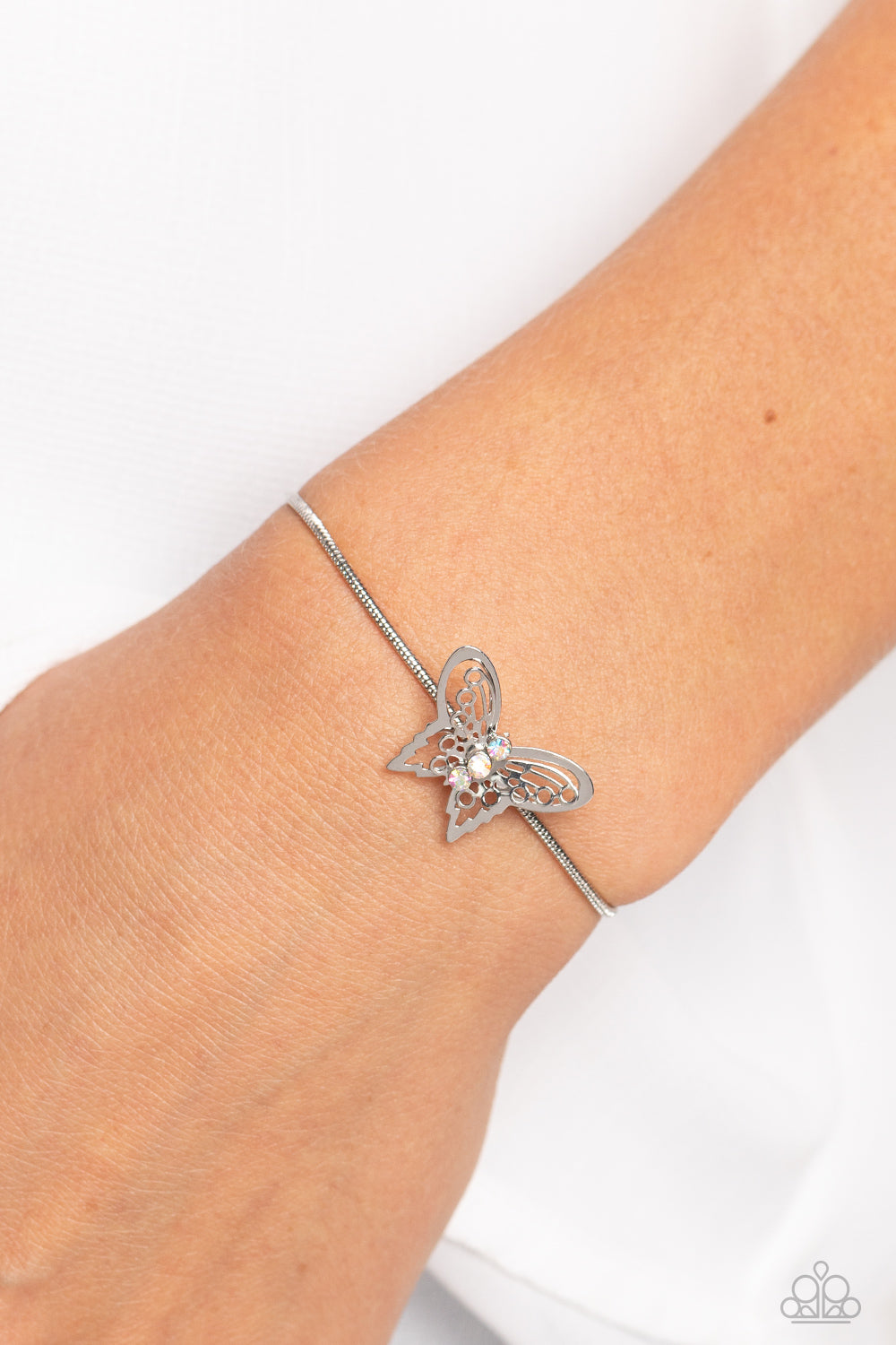 Paparazzi Accessories Wings of Wonder - Multi A deceptively simple silver butterfly charm glides along a silver snake chain for a whimsical flair along the wrist. Dainty, iridescent rhinestones encrust along the butterfly's body, creating an understated s