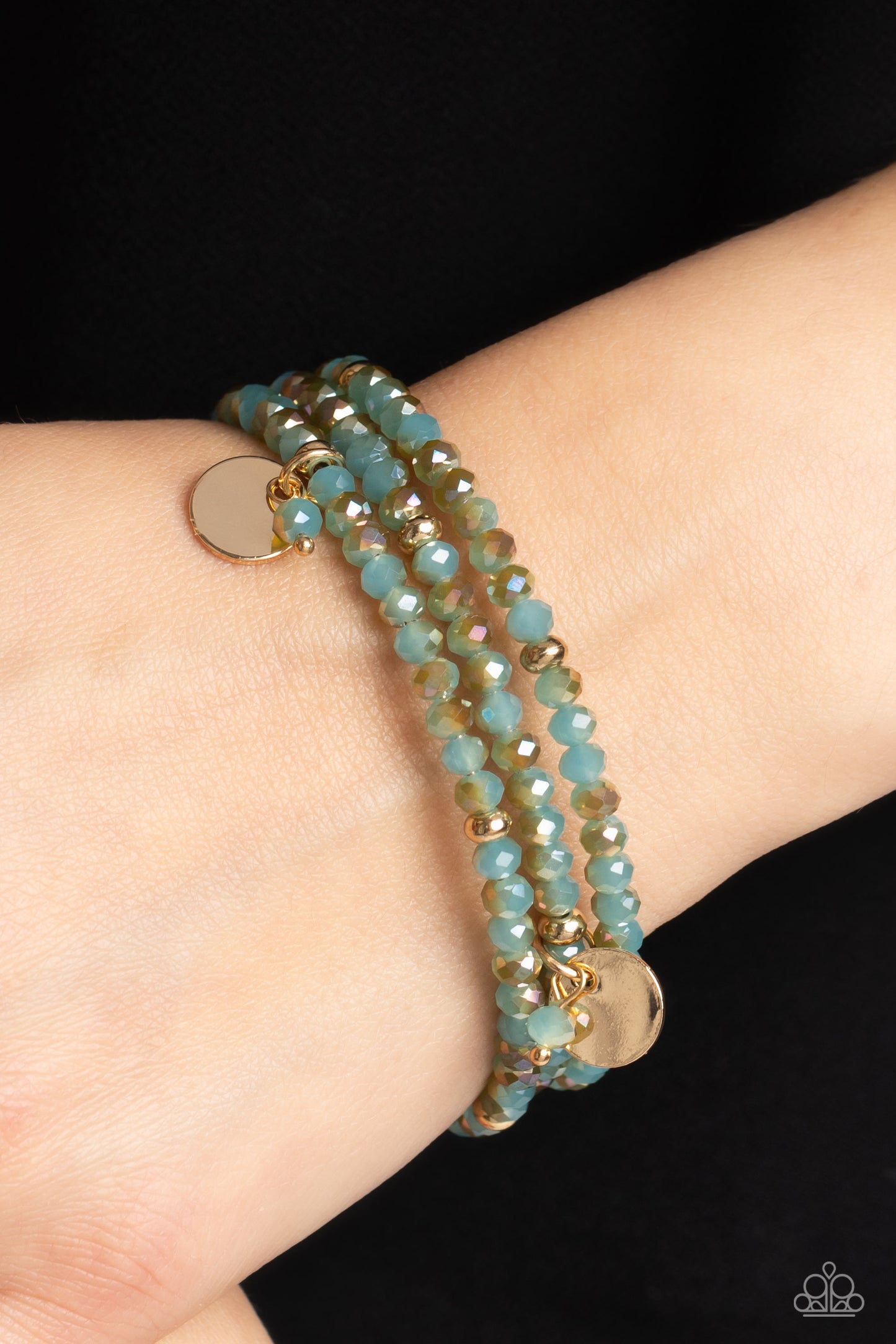 Paparazzi Accessories Illusive Infinity - Blue A dazzling collection of blue beads brushed with a golden undertone, gold studs, and gold discs are threaded along a coiled wire, creating a blinding infinity wrap style bracelet around the wrist. Sold as one