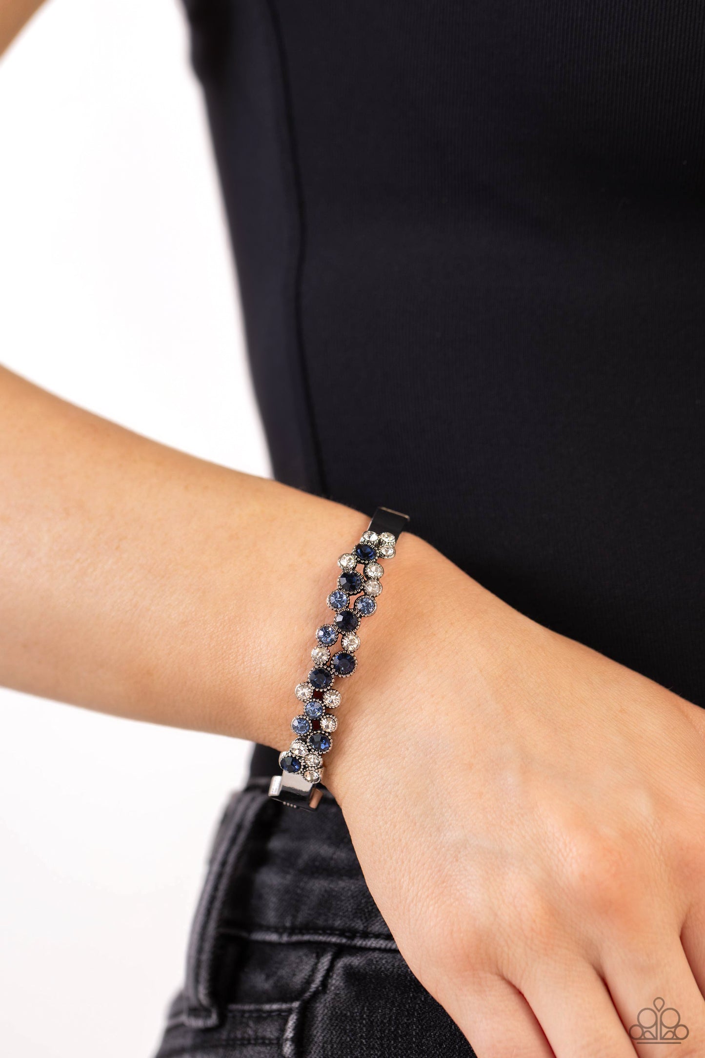 Paparazzi Accessories Big City Bling - Blue Featuring a crisscross pattern, a studded, framed collection of gems in varying sizes in shades of blue and white coalesce the top of a thick, silver bracelet for a pop of shimmery color atop the wrist. Features