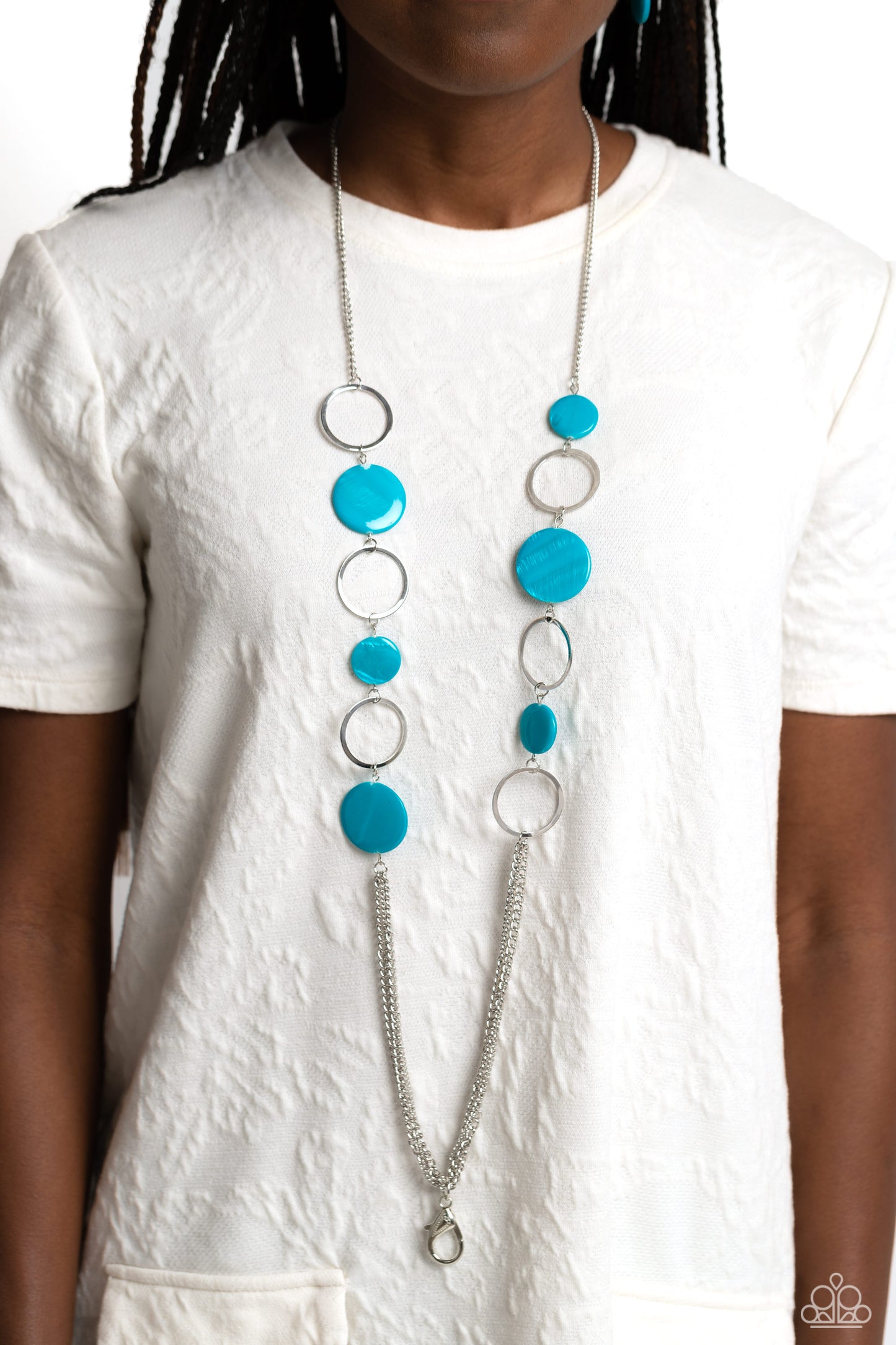 Paparazzi Accessories Beach Hub - Blue *Lanyard Sections of blue shell-like discs link with flat silver hoops down the chest, giving way to layers of shimmery silver chain for a tropical inspired flair. A lobster clasp hangs from the bottom of the design
