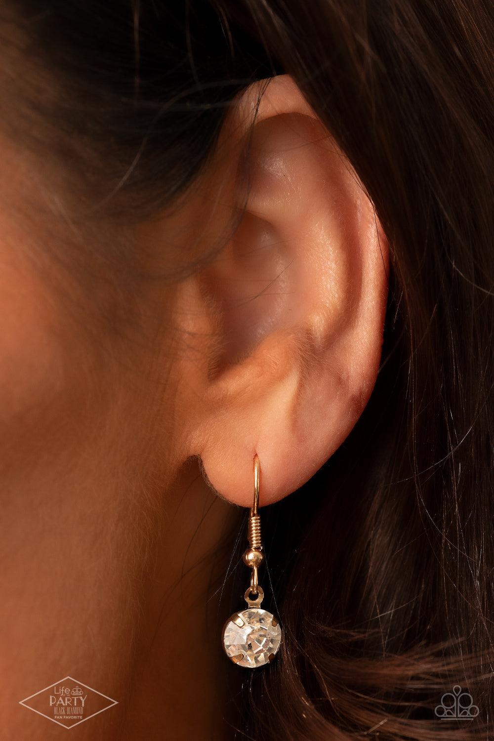 Paparazzi Accessories What A Gem - Gold A single rhinestone sparkles brilliantly at the bottom of a dainty gold chain, creating a stunning solitaire design. Features an adjustable clasp closure. Sold as one individual necklace. Includes one pair of matchi