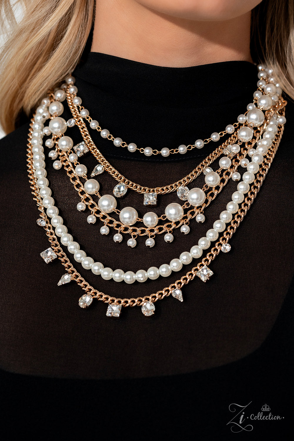 Paparazzi Accessories Aristocratic - Gold A mismatched collection of gold chains is layered with strands of pearly white beads to create luminous layers with charismatic chaos. Faceted white gems in an assortment of shapes are sporadically sprinkled along