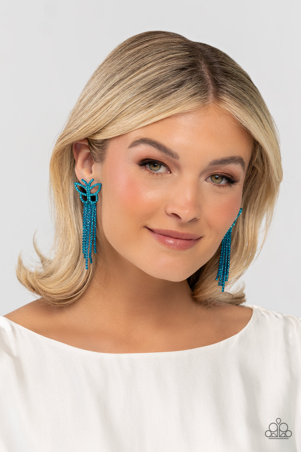 Paparazzi Accessories Billowing Butterflies - Blue Glassy blue rhinestones, encrusted along the front of a blue butterfly frame, create a whimsical centerpiece. Staggered rows of different blue rhinestones pressed in delicate blue square fittings cascade