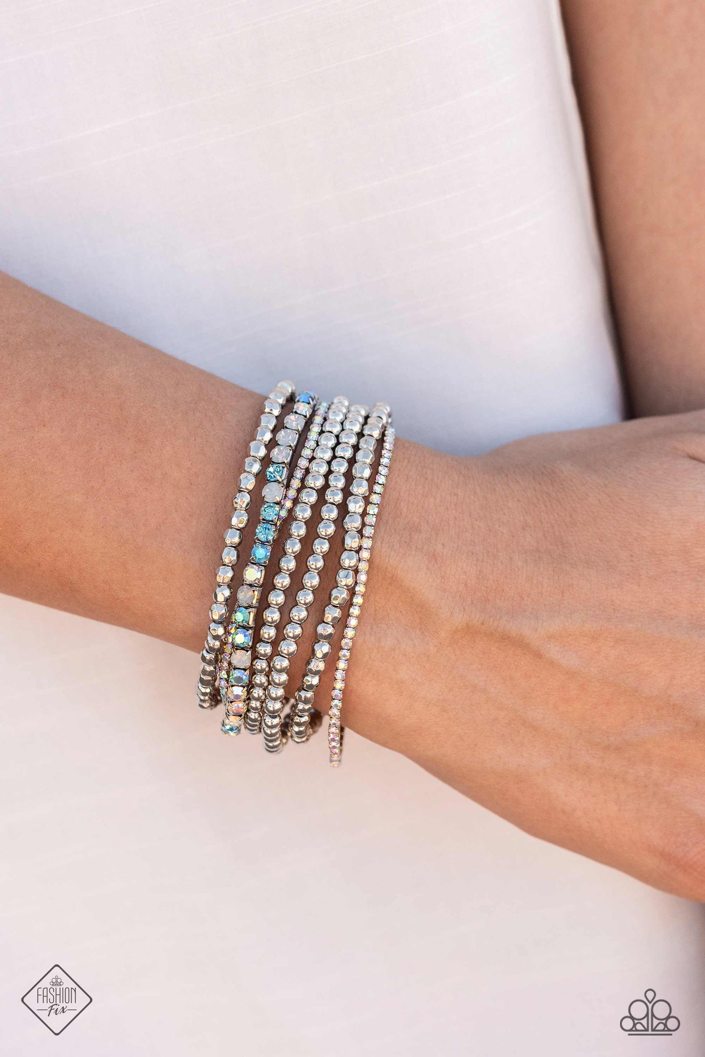 Paparazzi Accessories Stellar Sequence - Blue A mismatched collection of smooth and faceted silver beads collides with strands of aquamarine, opalescent, blue iridescent, and iridescent rhinestones set in square fittings to create an irresistibly stellar