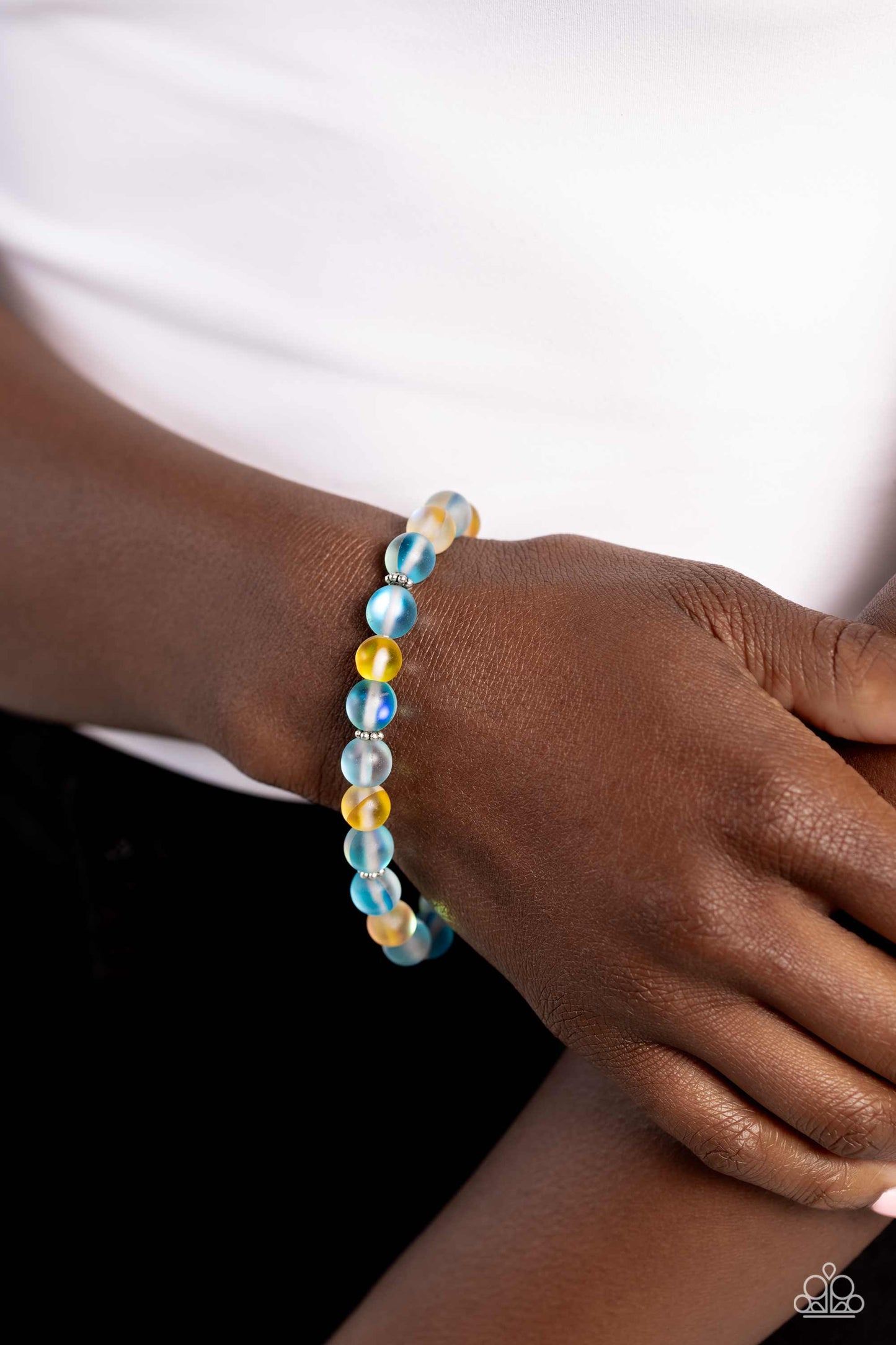 Paparazzi Accessories Clear Craze - Blue Infused with silver floral beads, a glassy collection of reflective blue and yellow-colored stone beads are threaded along an elastic stretchy band around the wrist for an adventurous pop of urban color. Sold as on
