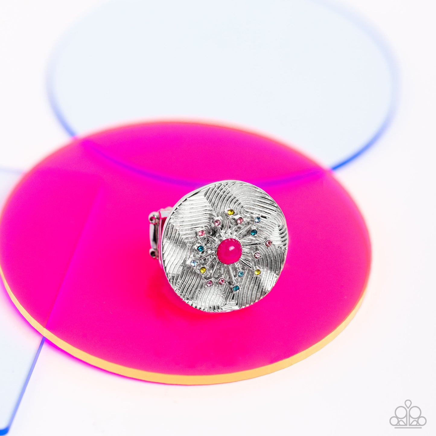 Paparazzi Accessories Seriously SUNBURST - Pink Featuring an oversized, textured backdrop, a dainty 3D sunburst detail, glistening with pink, blue, and olive green rhinestones and a Pink Peacock center standout atop the finger for a sunny pop of color. Fe