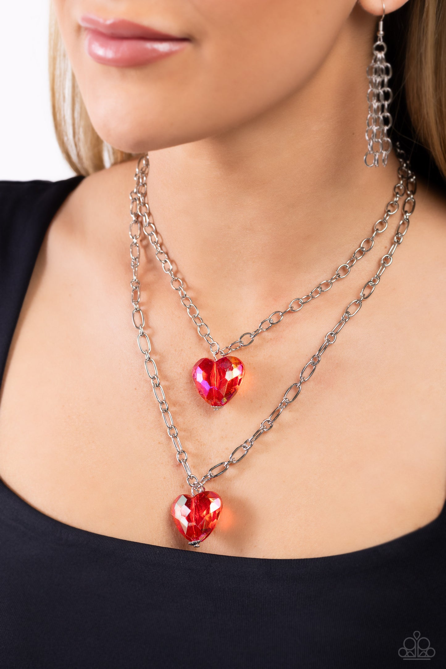 Paparazzi Accessories Layered Love - Red Featuring a subtle iridescent shimmer, two glassy red gem hearts are delicately suspended above one another on a paperclip and silver oval link chain for a whimsical double-stacked display. Features an adjustable c