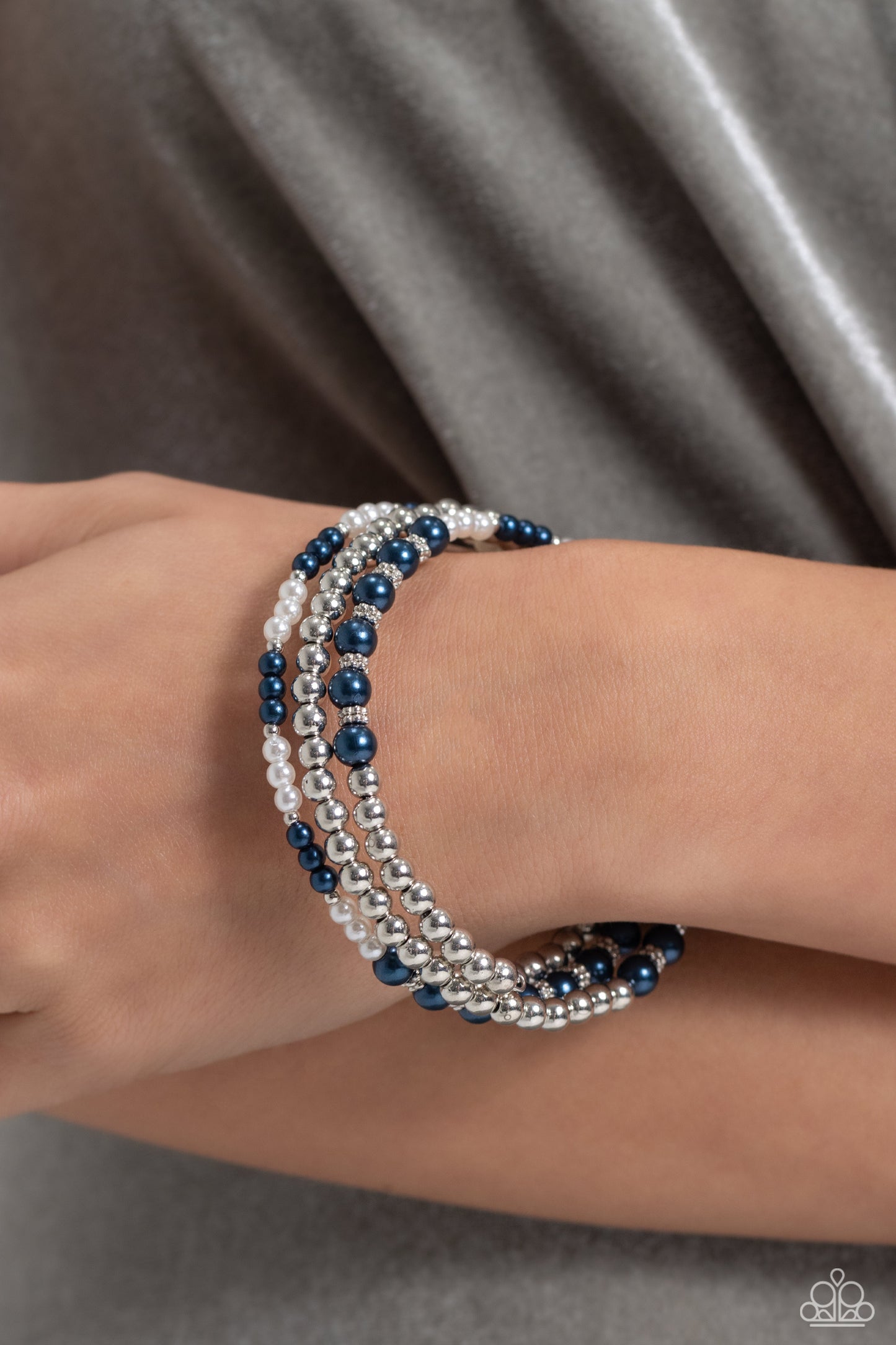 Paparazzi Accessories Just SASSING Through - Blue A collection of bright Montana pearls, white pearls, shiny silver beads and accents are threaded along a wire that coils around the wrist, creating an eye-catching infinity wrap style bracelet. Sold as one