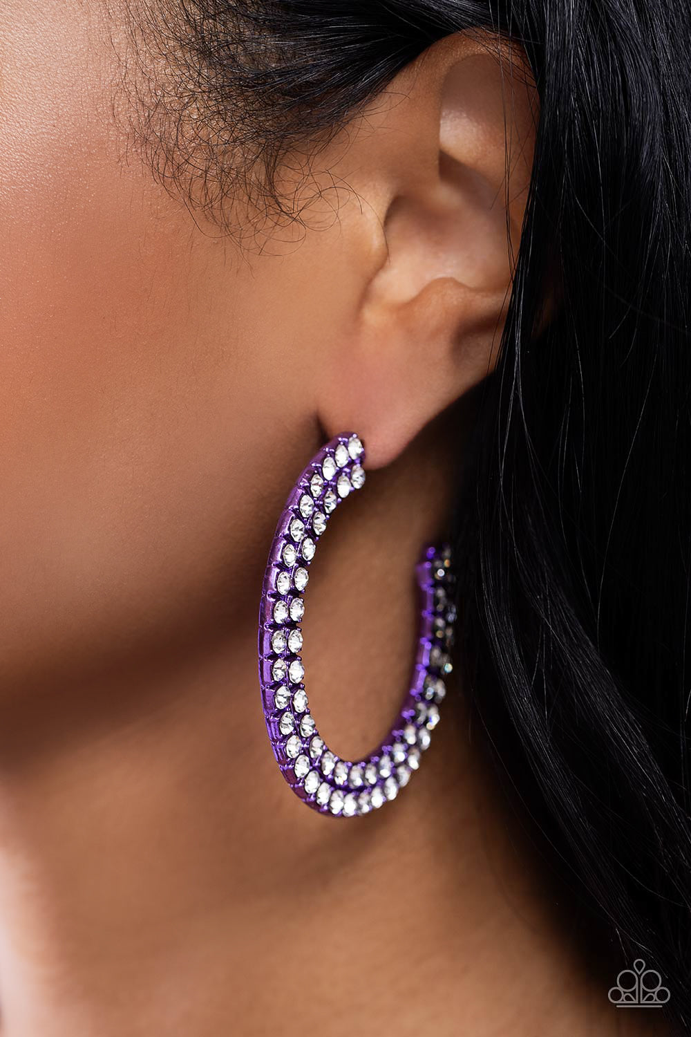 Paparazzi Accessories Flawless Fashion - Purple The outer curve of an oversized thick metallic purple hoop is encrusted in a staggered double row of dazzling white rhinestones for a flawless look. Earring attaches to a standard post fitting. Hoop measures