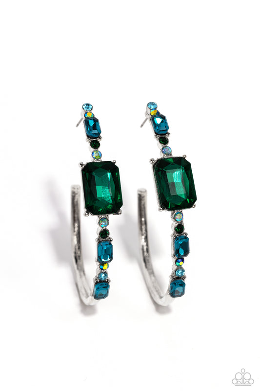 Paparazzi Accessories Elite Ensemble - Green Encrusted in round and emerald-cut aquamarine and emerald gems, some featuring an iridescent sheen, an exaggerated oblong silver hoop curls around the ear, refracting light in a dramatic, knockout finish. Earri