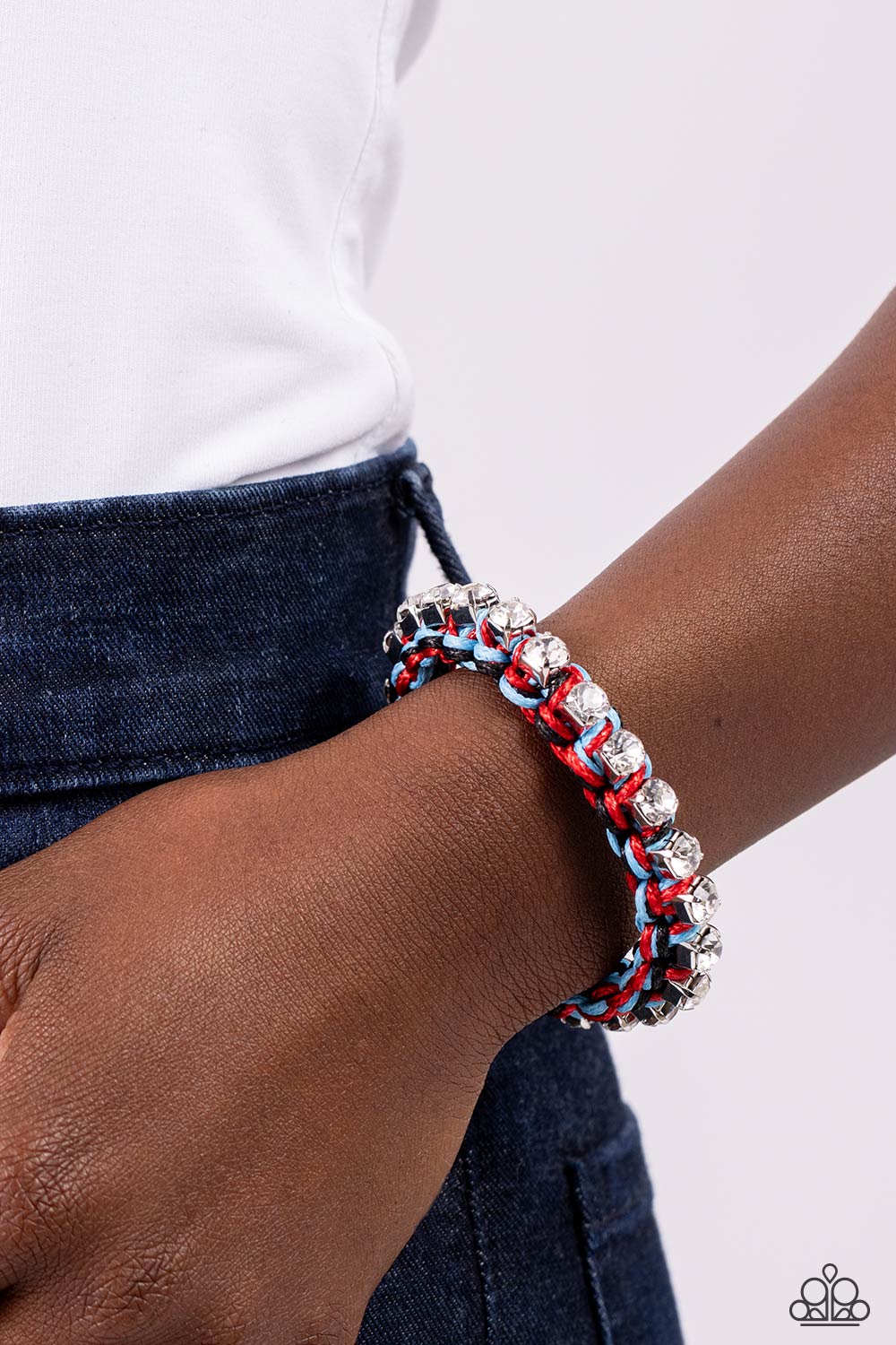 Paparazzi Accessories The Next Big STRING - Black Strands of black, blue, and red cording ornately weave across the wrist, creating an earthy braid. Sporadically dotted through the cording, white rhinestones, set in silver square fittings add a bit of liv