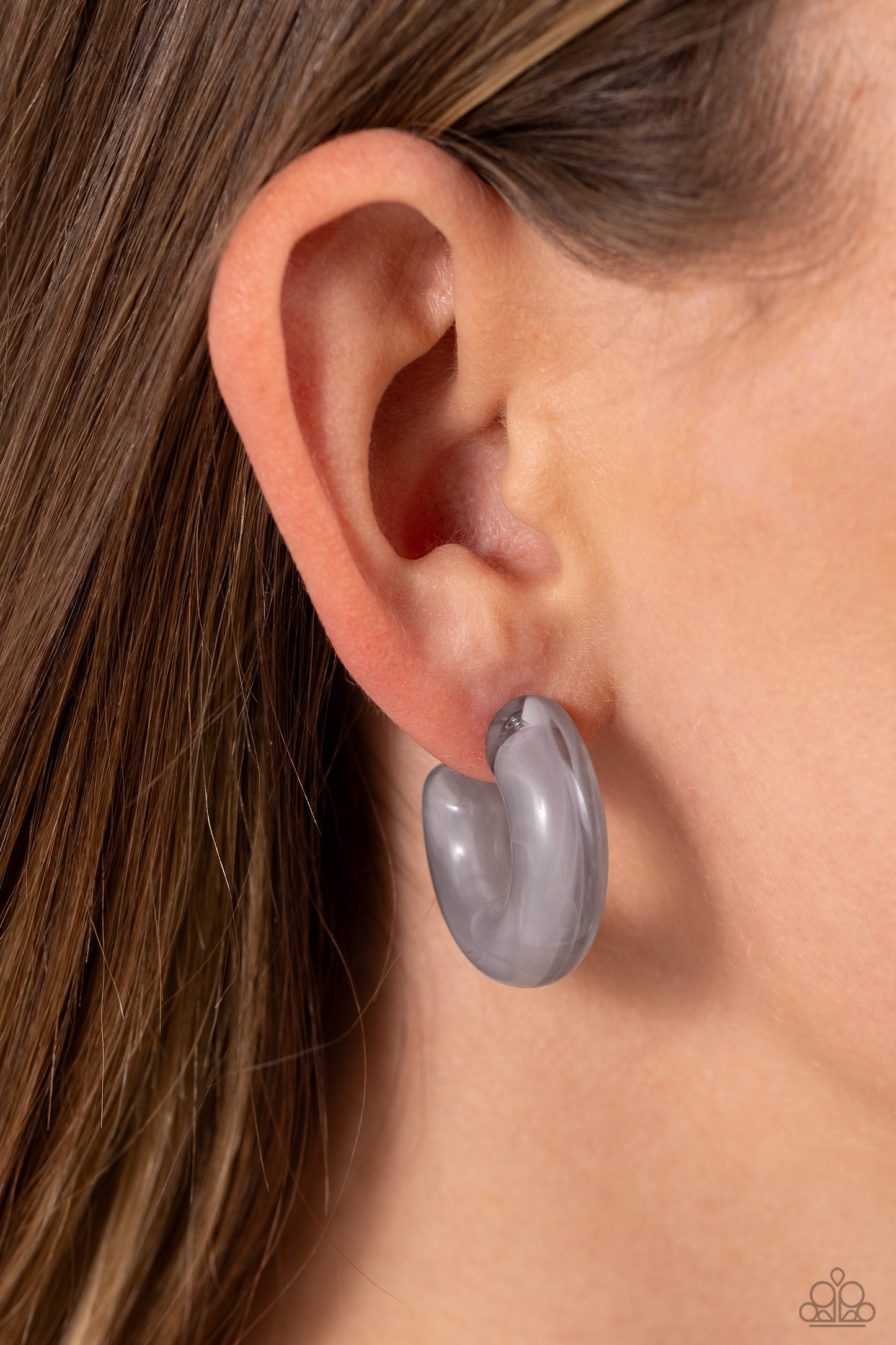 Paparazzi Accessories Acrylic Acclaim - Silver Featuring a milky accent, thick gray acrylic frames snugly loop and curl just below the ear for a fashionable finish. Earring attaches to a standard post fitting. Hoop measures approximately 1" in diameter. S