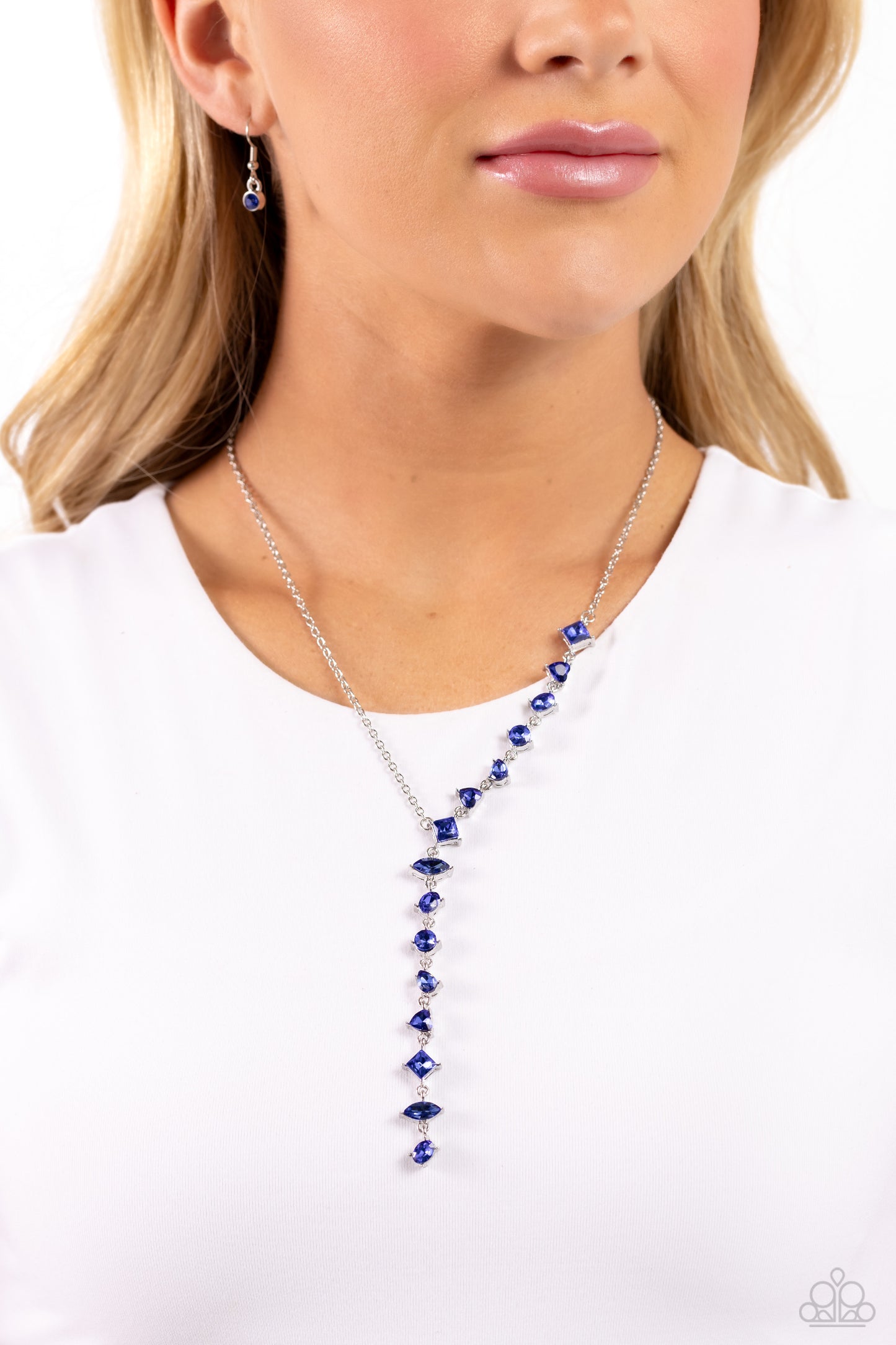 Paparazzi Accessories Diagonal Daydream - Blue Featuring a pronged fitting, a collection of royal blue square-cut, heart, oval, round, and teardrop gems cascade down the neckline in a diagonal pattern, creating an intense, incandescent statement piece. Fe