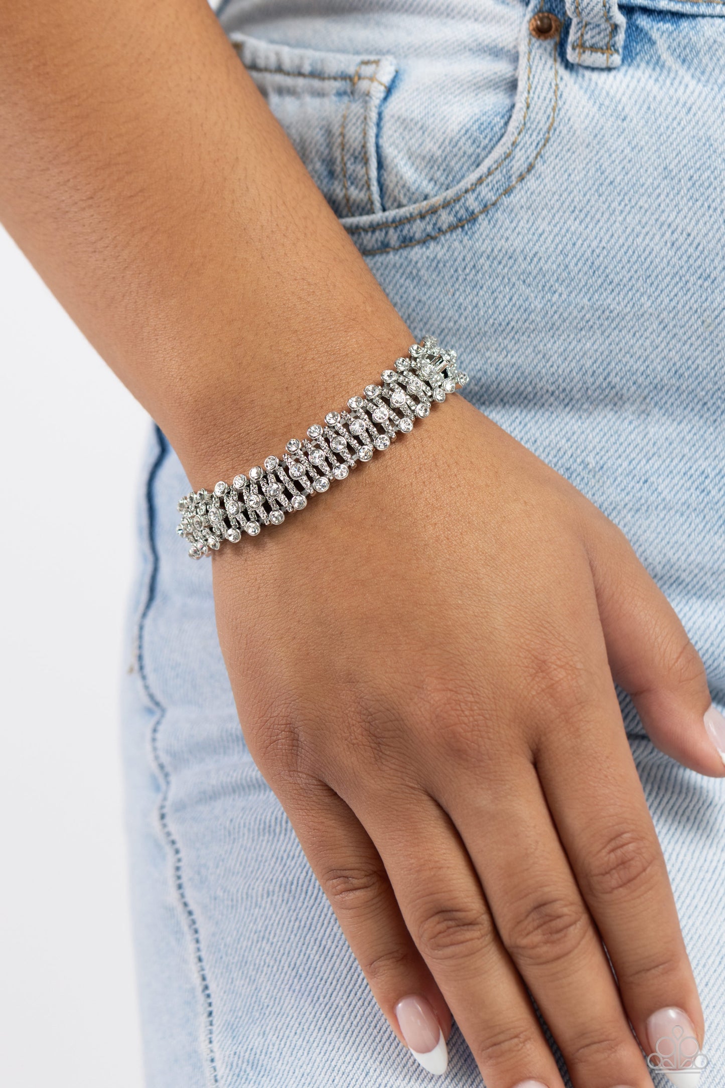 Paparazzi Accessories Corporate Confidence - White Infused along a stretchy band, studded, curved silver bars dotted with white rhinestones wraps around the wrist for a glitzy display. Sold as one individual bracelet. Jewelry