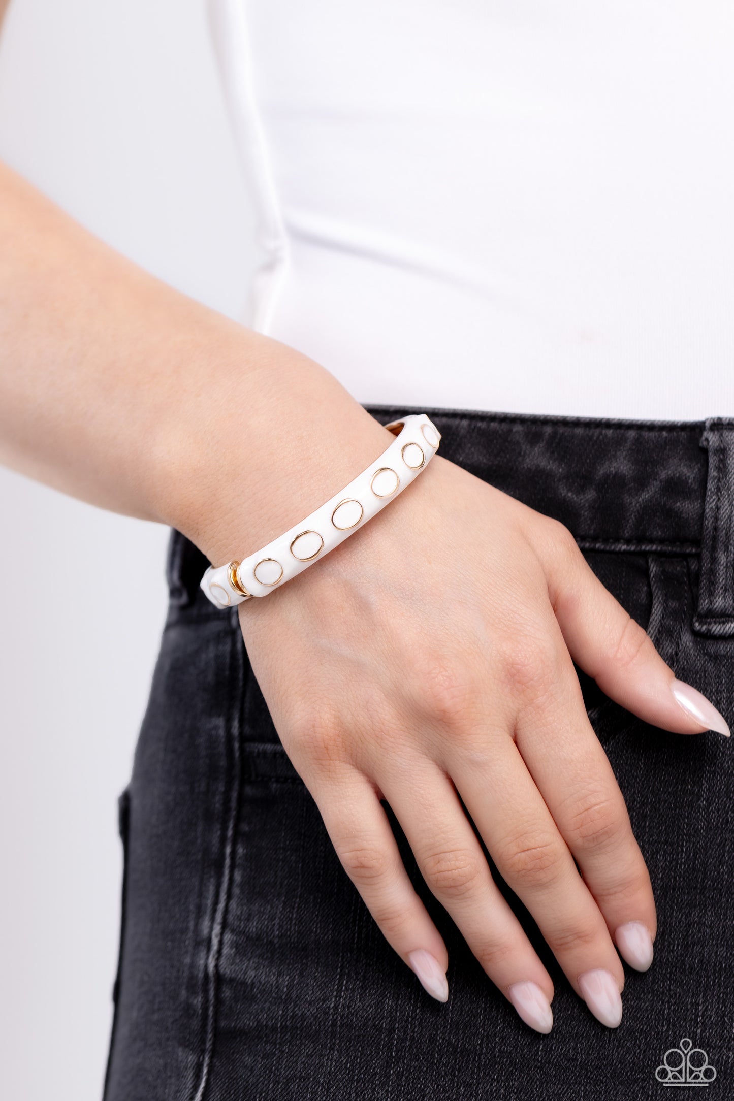 Paparazzi Accessories Delightful Diversion - White Embedded along a white-painted, scalloped cuff, sleek gold rings dot across the center of the wrist for a versatile pop of color. Features a hinged closure. Sold as one individual bracelet. Jewelry