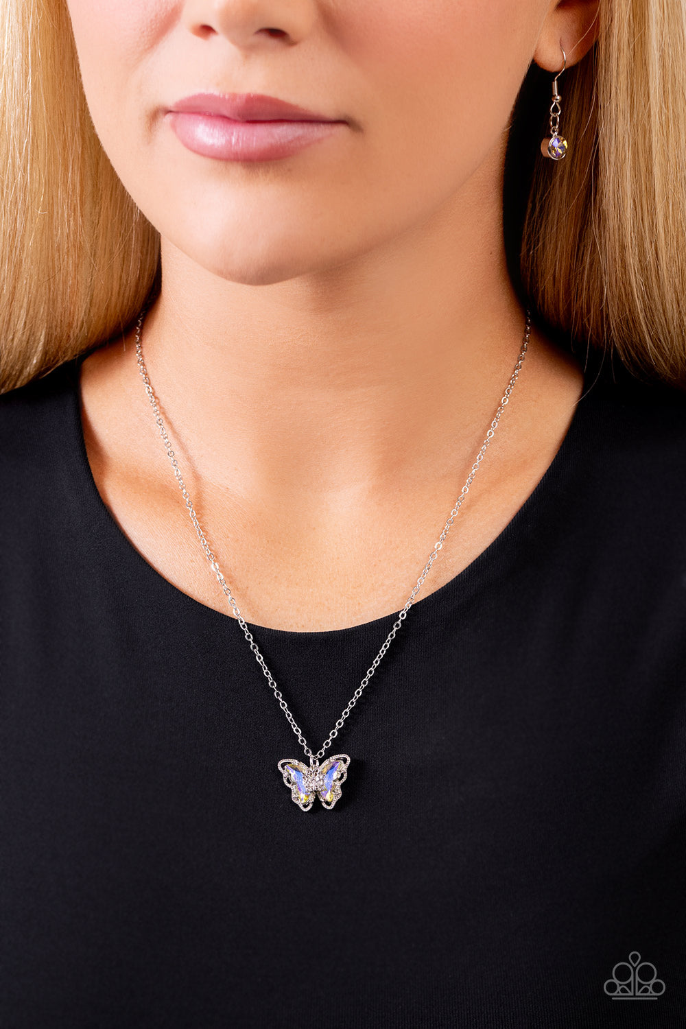 Paparazzi Accessories Whispering Wings - Yellow A whimsical yellow UV-brushed butterfly with a silver-studded outline elegantly slides along a dainty silver chain. A smaller white rhinestone-encrusted silver butterfly is nestled at the center of the large