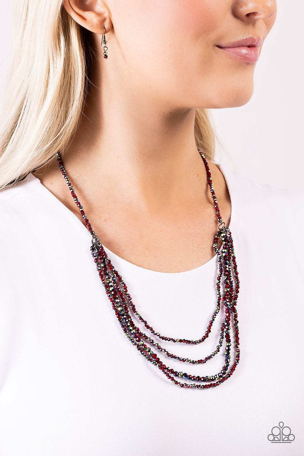Paparazzi Accessories Candescent Cascade - Red Dipped in a metallic sheen, a strand of faceted red and UV beads coalesce down the chest. Four of the same beaded strands cascade in layers from the single strand for a glamorous finish. Features an adjustabl