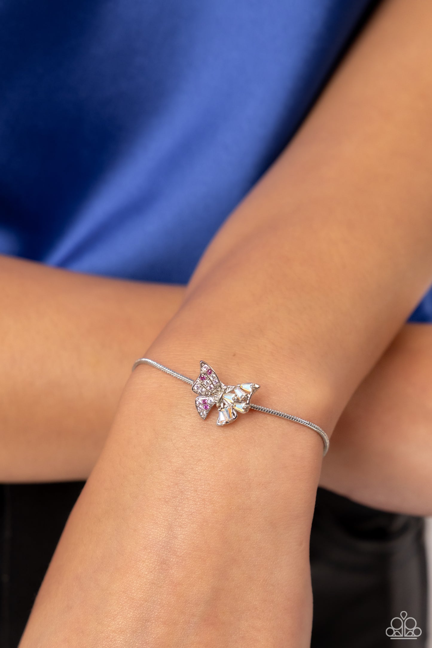 Paparazzi Accessories Adjustable Allure - Pink Dotted with various pink rhinestones and emerald-cut iridescent gems, a silver butterfly flutters along a strand of shiny silver snake chain around the wrist for a wildly whimsical look. Features an adjustabl