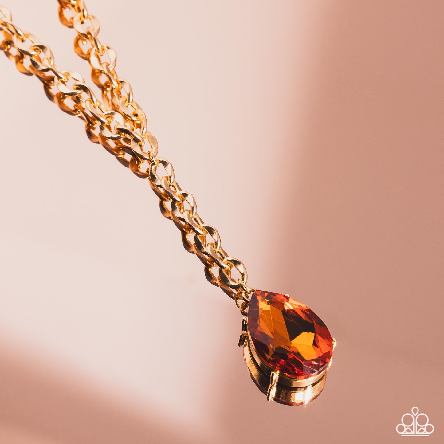 Paparazzi Accessories Benevolent Bling - Gold Set in an elevated gold-pronged frame, a faceted topaz teardrop gem cascades from an oblong, abstract gold ring chain that extends past the collar for a blinding statement. Features an adjustable clasp closure