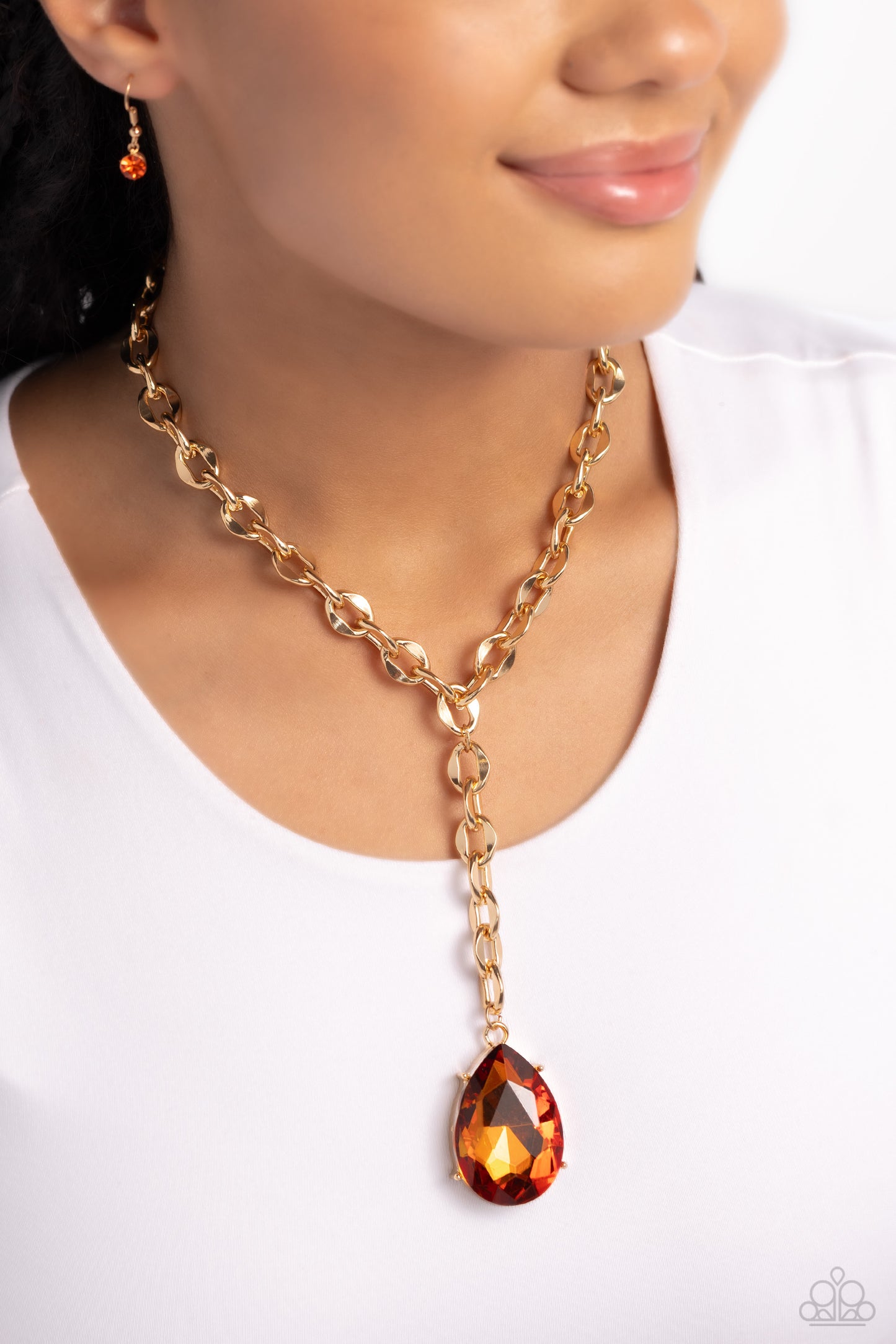 Paparazzi Accessories Benevolent Bling - Gold Set in an elevated gold-pronged frame, a faceted topaz teardrop gem cascades from an oblong, abstract gold ring chain that extends past the collar for a blinding statement. Features an adjustable clasp closure