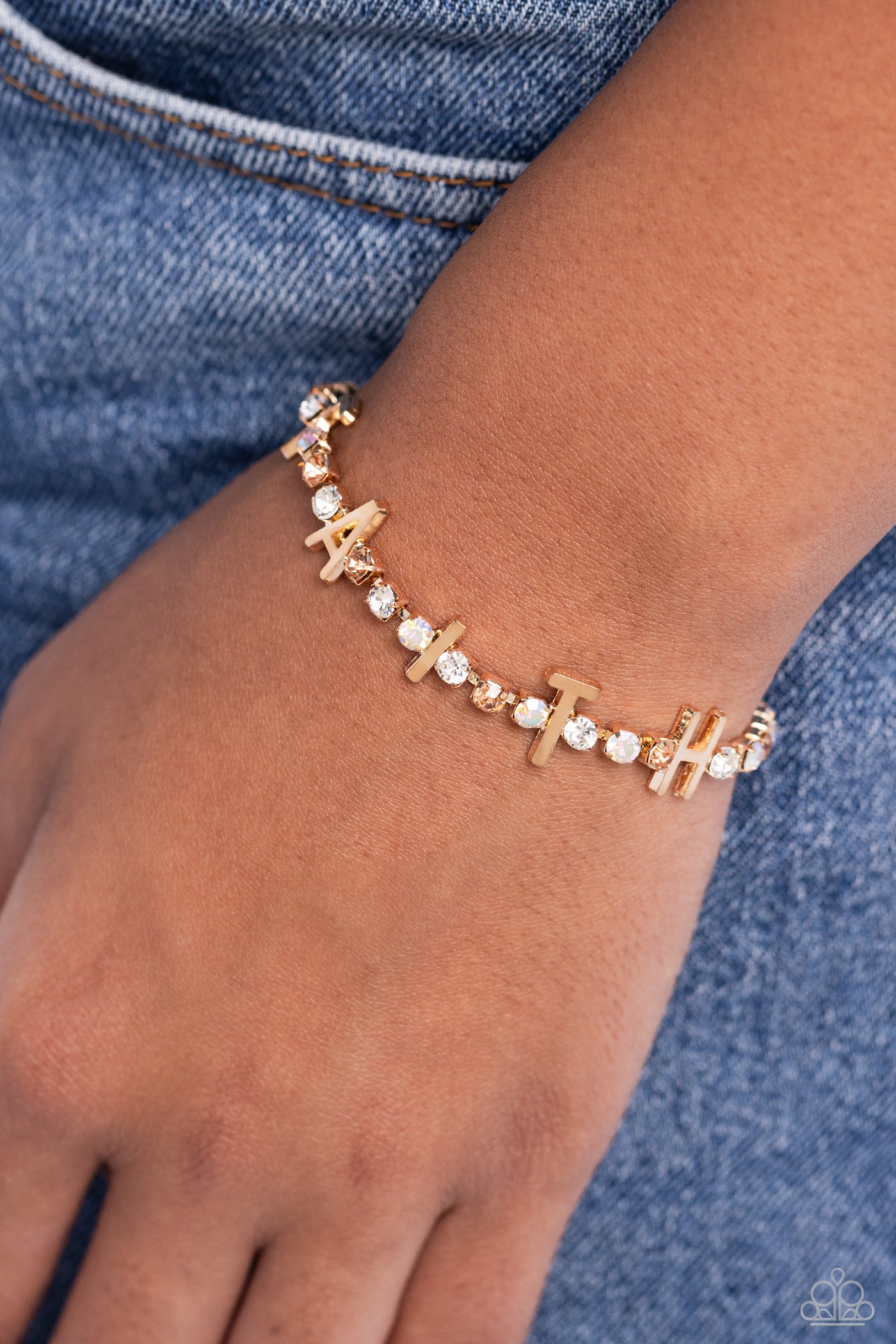 Paparazzi Accessories In Good Faith - Gold Set in gold square fittings, various multicolored rhinestones gleam around the wrist. Infused along the design, sleek gold letters spell out the word "FAITH" for an inspirational finish. Features an adjustable cl