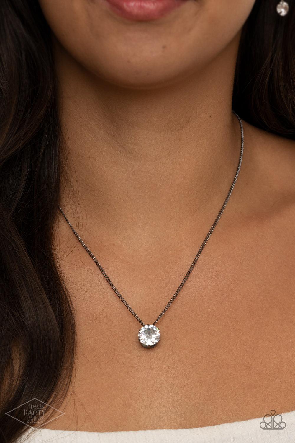 Paparazzi Accessories What A Gem - Gunmetal A single rhinestone sparkles brilliantly at the bottom of a dainty gunmetal chain, creating a stunning solitaire design. Features an adjustable clasp closure. Sold as one individual necklace. Includes one pair o