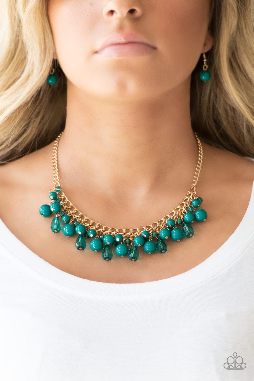 Paparazzi Accessories Tour de Trendsetter - Green Varying in shape, glassy and polished Quetzal Green beads swing from the bottom of interlocking gold chains. Crystal-like teardrops are sprinkled along the colorful beading, creating a flirtatious fringe b