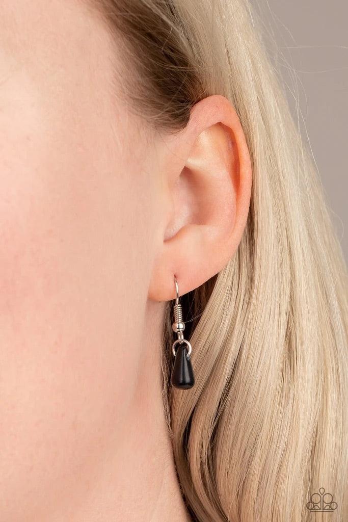 Paparazzi Accessories Extinct Species - Black Black teardrop stones and classic silver beads are threaded along an invisible wire. The earthy beads alternate below the collar, creating a wild fringe. Features an adjustable clasp closure. Sold as one indiv