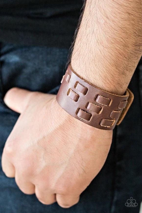 Paparazzi Accessories Rodeo Rampage - Brown Rustic strips of leather are laced through a thick brown leather band, creating a rustic look around the wrist. Features an adjustable snap closure. Sold as one individual bracelet. Jewelry