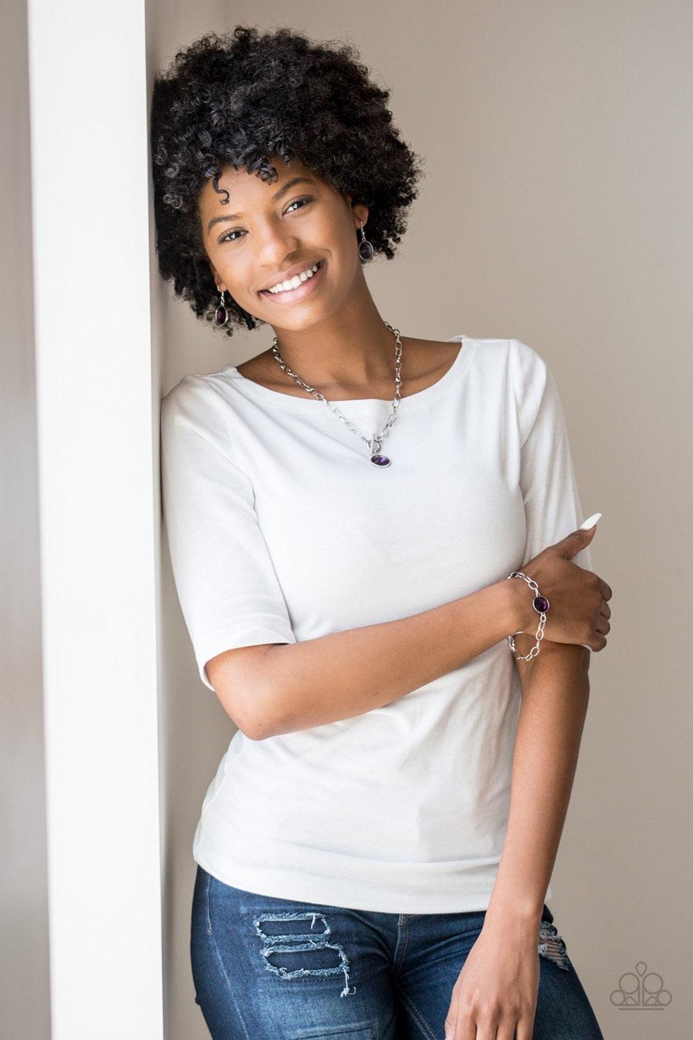 Paparazzi Accessories All Aglitter - Purple A dramatic purple gem attaches to a shiny silver chain, creating a blinding centerpiece atop the wrist. Features a toggle closure. Jewelry