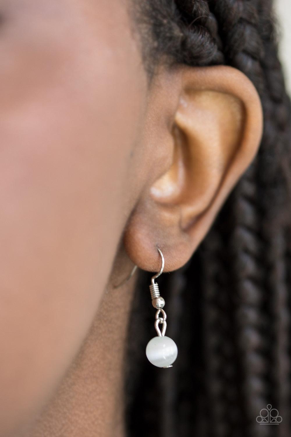 Paparazzi Accessories Magically Modern - White A glowing white moonstone is pressed into an asymmetrical silver frame, creating a whimsical pendant. Features an adjustable clasp closure. Sold as one individual necklace. Includes one pair of matching earri