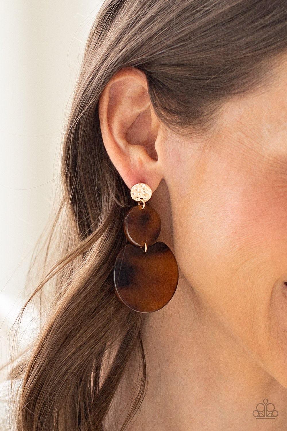 Paparazzi Accessories Miami Mariner - Gold Brushed in a shell-like iridescence, spotted brown frames trickle from a hammered gold frame for a retro look. Earring attaches to a standard post fitting. Jewelry