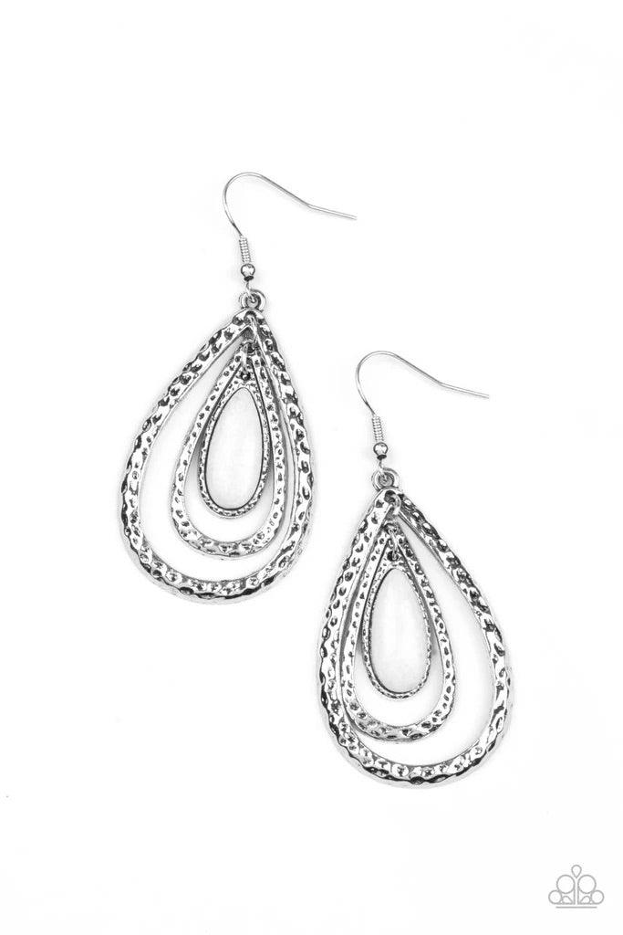 Paparazzi Accessories Teardrop Torrent - White A white teardrop stone swings from the top of a hammered silver frame that links to a larger hammered silver frame, creating a rippling lure. Earring attaches to a standard fishhook fitting. Sold as one pair