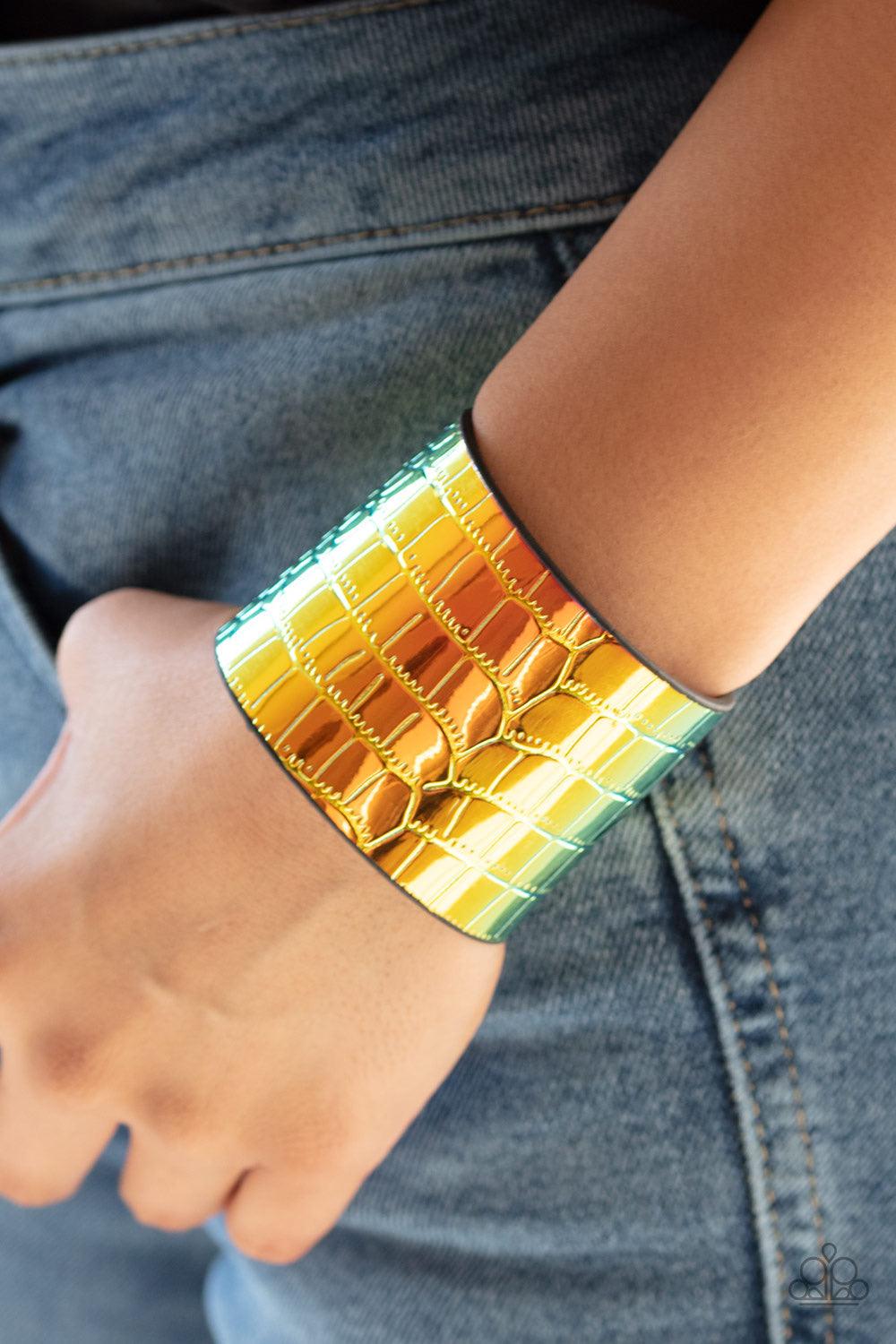Paparazzi Accessories Chroma Croc - Multi Featuring a rainbow chrome-like finish, a croc patterned leather band curls around the wrist for a statement-making look. Features an adjustable snap closure. Jewelry