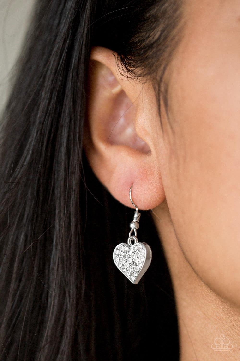 Paparazzi Accessories Harvard Hearts - White Encrusted in glassy white rhinestones, a dainty silver heart swings from the bottom of a glistening silver chain for a classic look. Features a toggle closure. Jewelry