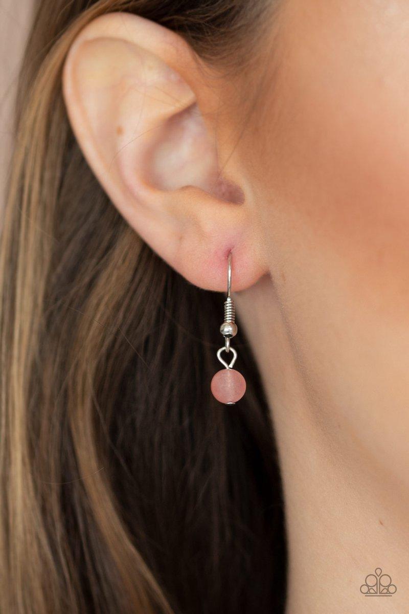 Paparazzi Accessories Dewy Desert - Pink Nestled in a sleek silver frame, a dewy pink stone swings from the bottom of a hammered silver hoop at the bottom of a shiny silver chain. Dainty silver chains stream from the bottom of the tranquil stone pendant,