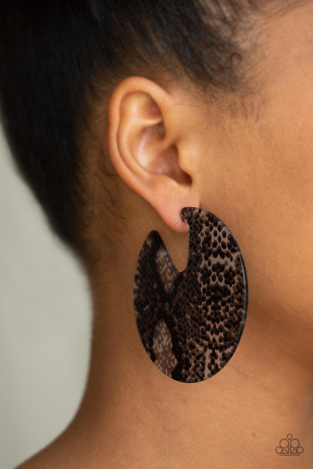 Paparazzi Accessories Hit or HISS - Black Featuring a python pattern, an abstract acrylic hoop curls around the ear for a retro look. Earring attaches to a standard post fitting. Hoop measures approximately 2 3/4" in diameter. Jewelry