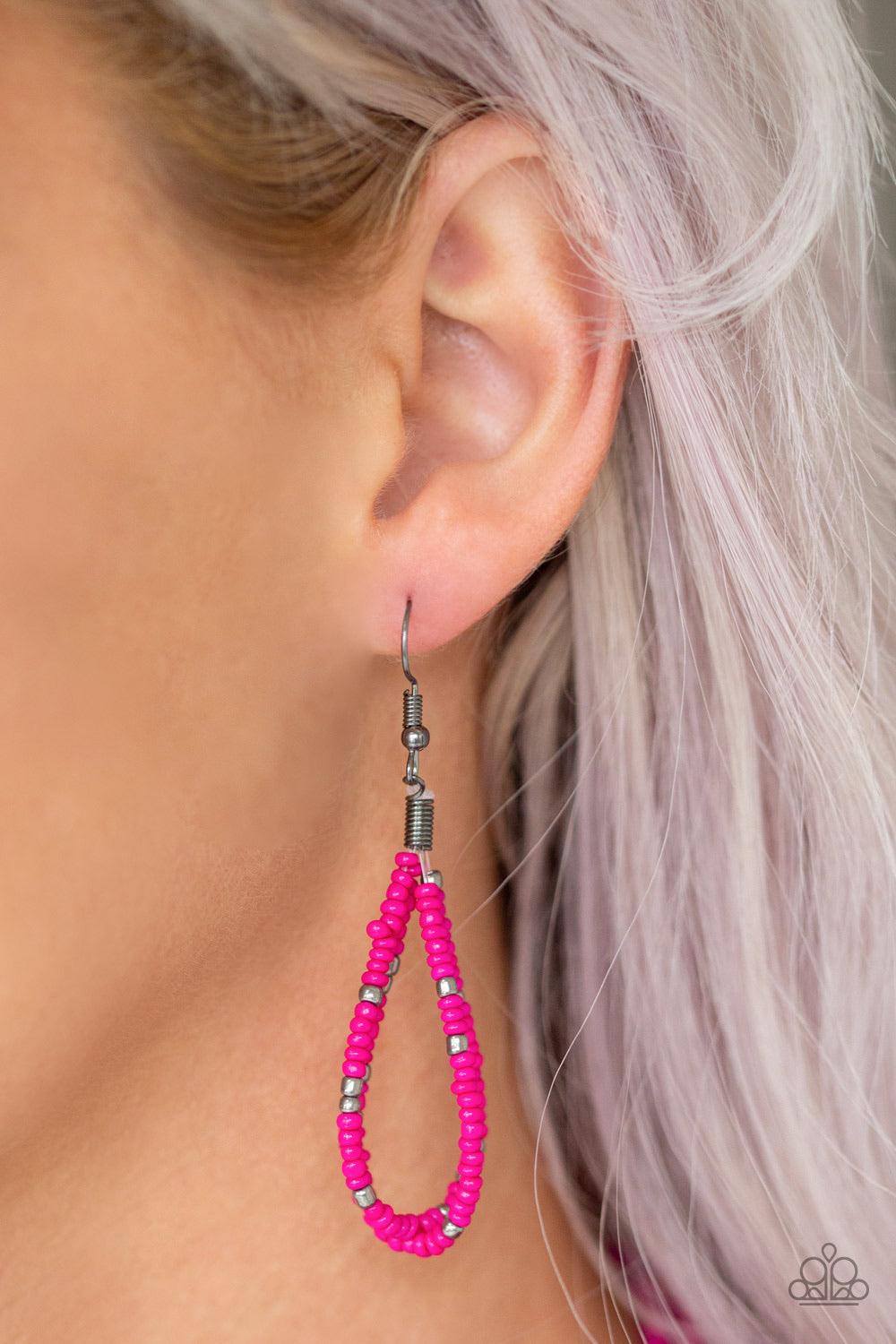 Paparazzi Accessories Rio Rainforest - Pink Suspended between two gunmetal fittings, row after row of countless strands of Pink Peacock seed beads layer below the collar. Dainty gunmetal seed beads are sprinkled across the strands for a seasonal finish. F