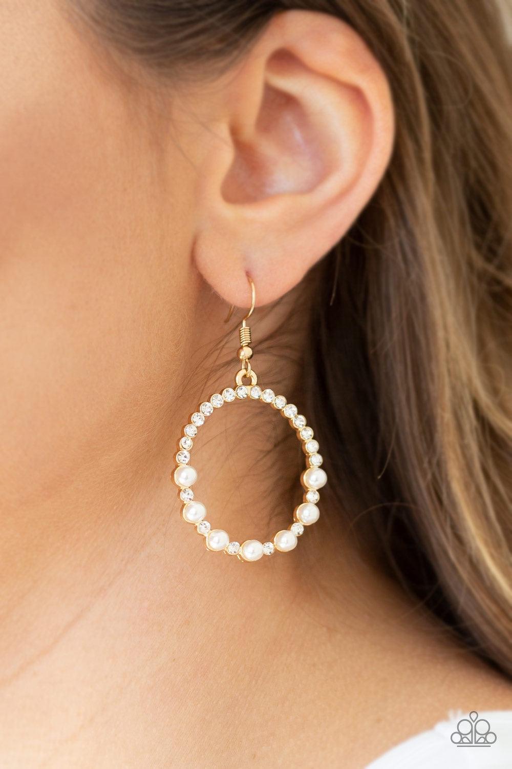 Paparazzi Accessories Glowing Grandeur - Gold Encrusted in glassy white rhinestones, the bottom of a glistening gold hoop is dotted in bubbly white pearls for a refined fashion. Earring attaches to a standard fishhook fitting. Jewelry