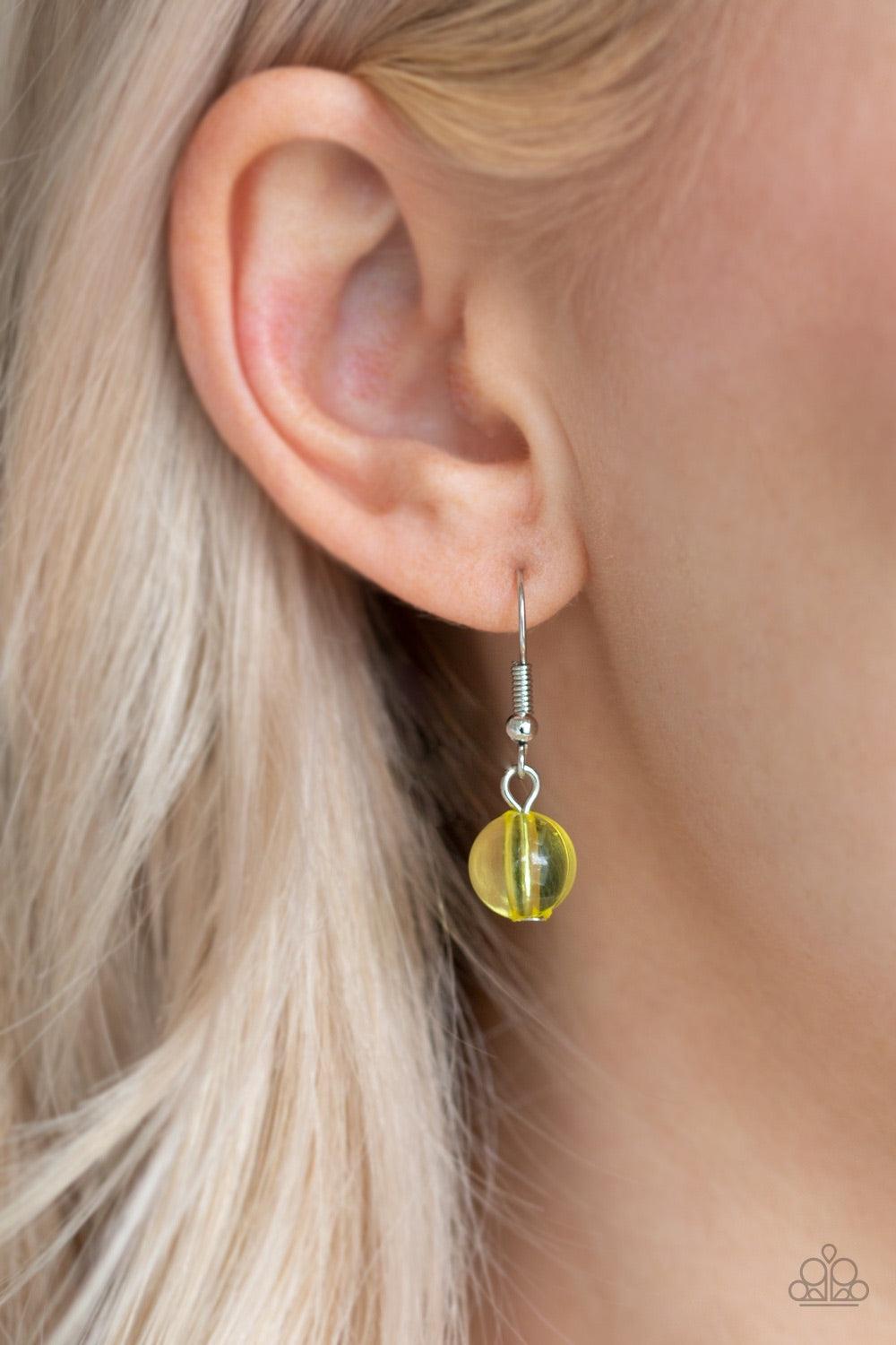 Paparazzi Accessories Beauty School Drop Out - Yellow Faceted crystal-like teardrops in a gorgeous yellow hue dance along the neckline with shiny silver beads and smaller yellow crystal-like beads creating a dramatic flair. Features an adjustable clasp cl