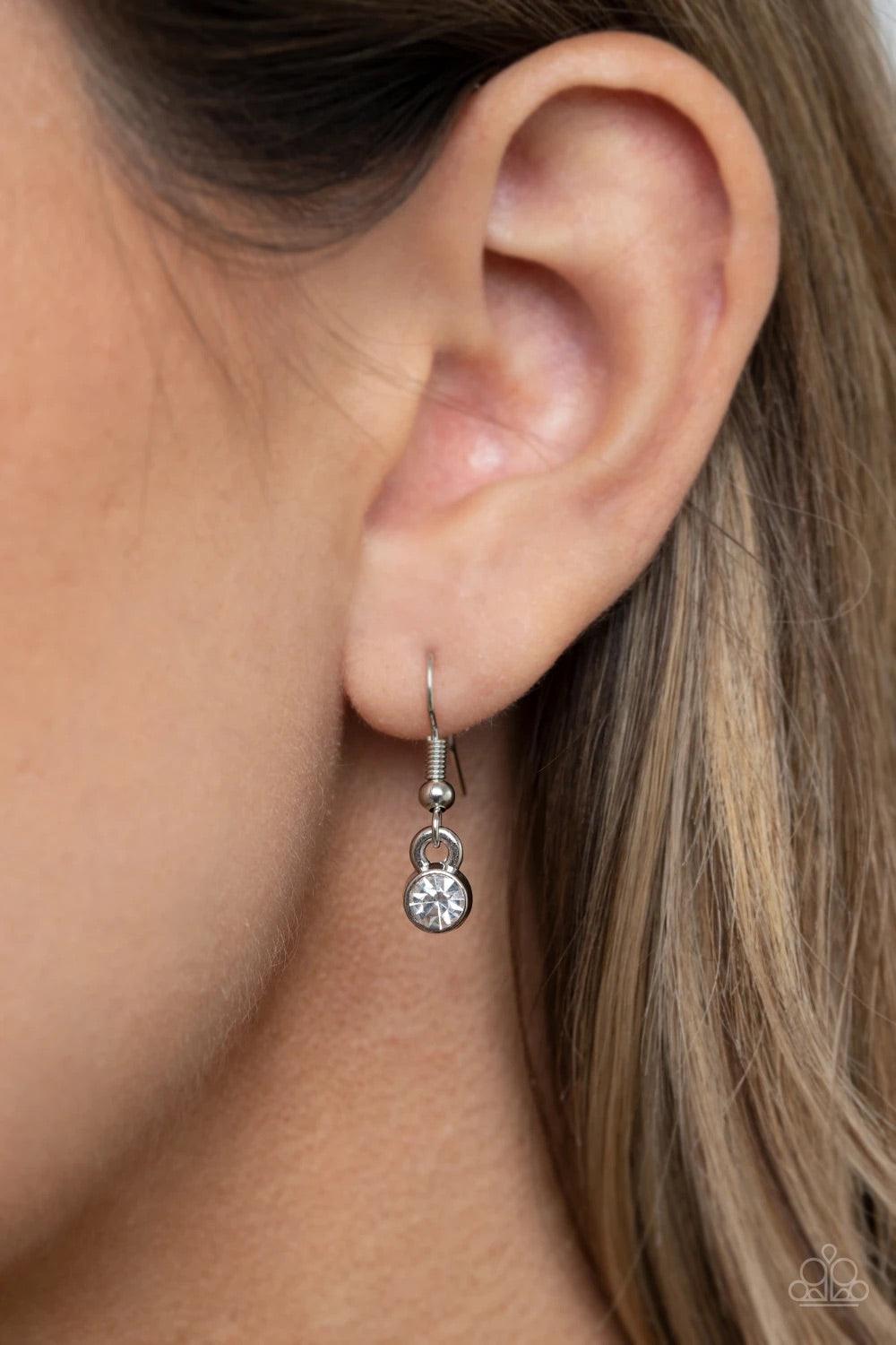 Paparazzi Accessories REIGN Them In - Green A dramatically oversized green gem is pressed into the center of a curvy silver frame dusted in dainty white rhinestones, creating a glamorous pendant at the bottom of a lengthened silver chain. Features an adju