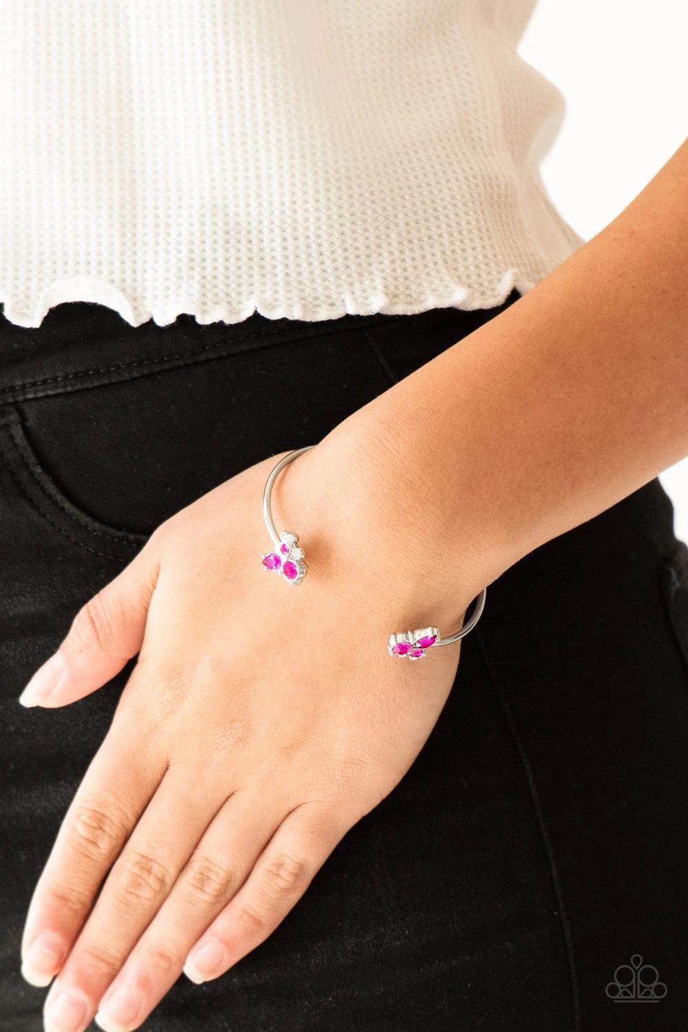 Paparazzi Accessories Going For Glitter - Pink Varying in shape, glittery pink and white rhinestones join at both ends of a dainty silver cuff, creating refined fittings. Sold as one individual bracelet. Jewelry