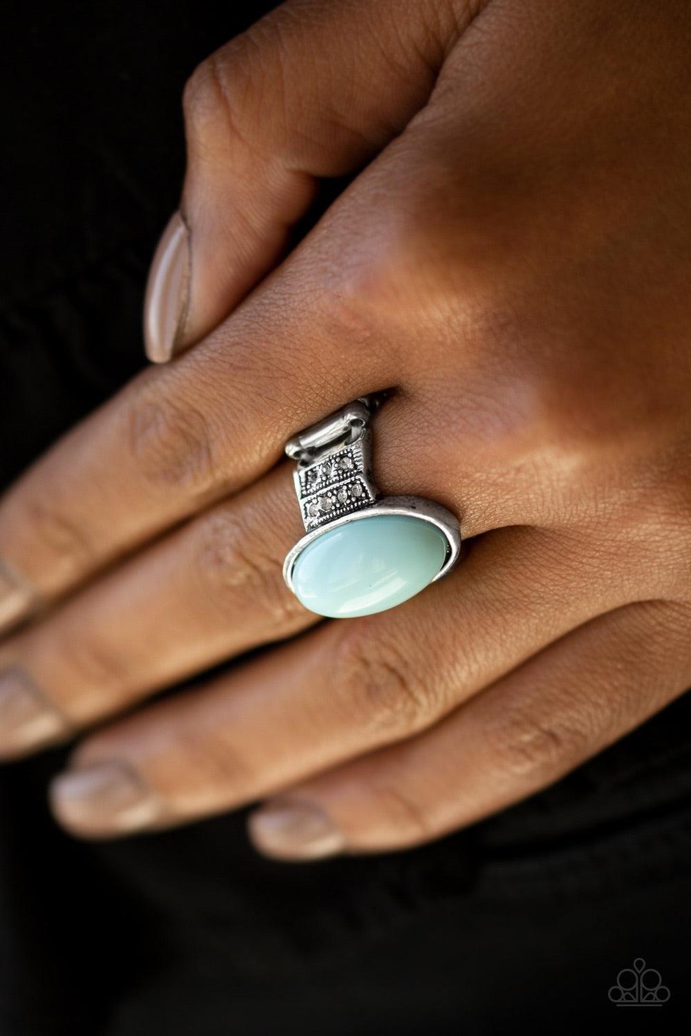 Paparazzi Accessories BEAD-To-Know Basis - Blue An oval blue bead adorns the center of an ornate silver band encrusted in rows of glittery white rhinestones for a seasonal look. Features a stretchy band for a flexible fit. Jewelry
