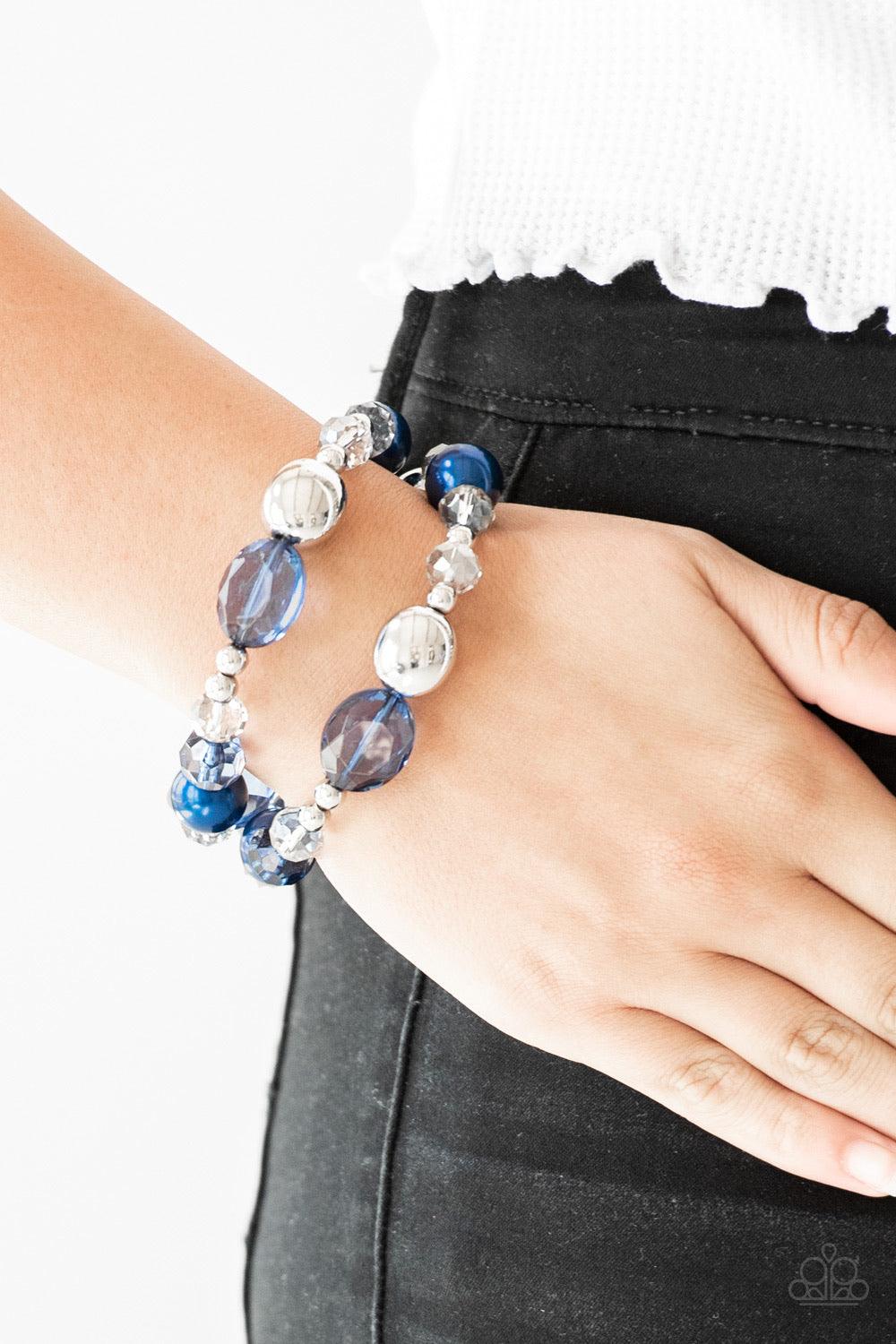 Paparazzi Accessories Downtown Dazzle - Blue An array of blue pearls, shiny silver beads, and metallic crystal-like beads are threaded along stretchy bands around the wrist for a refined look. Sold as one set of two bracelets. Jewelry